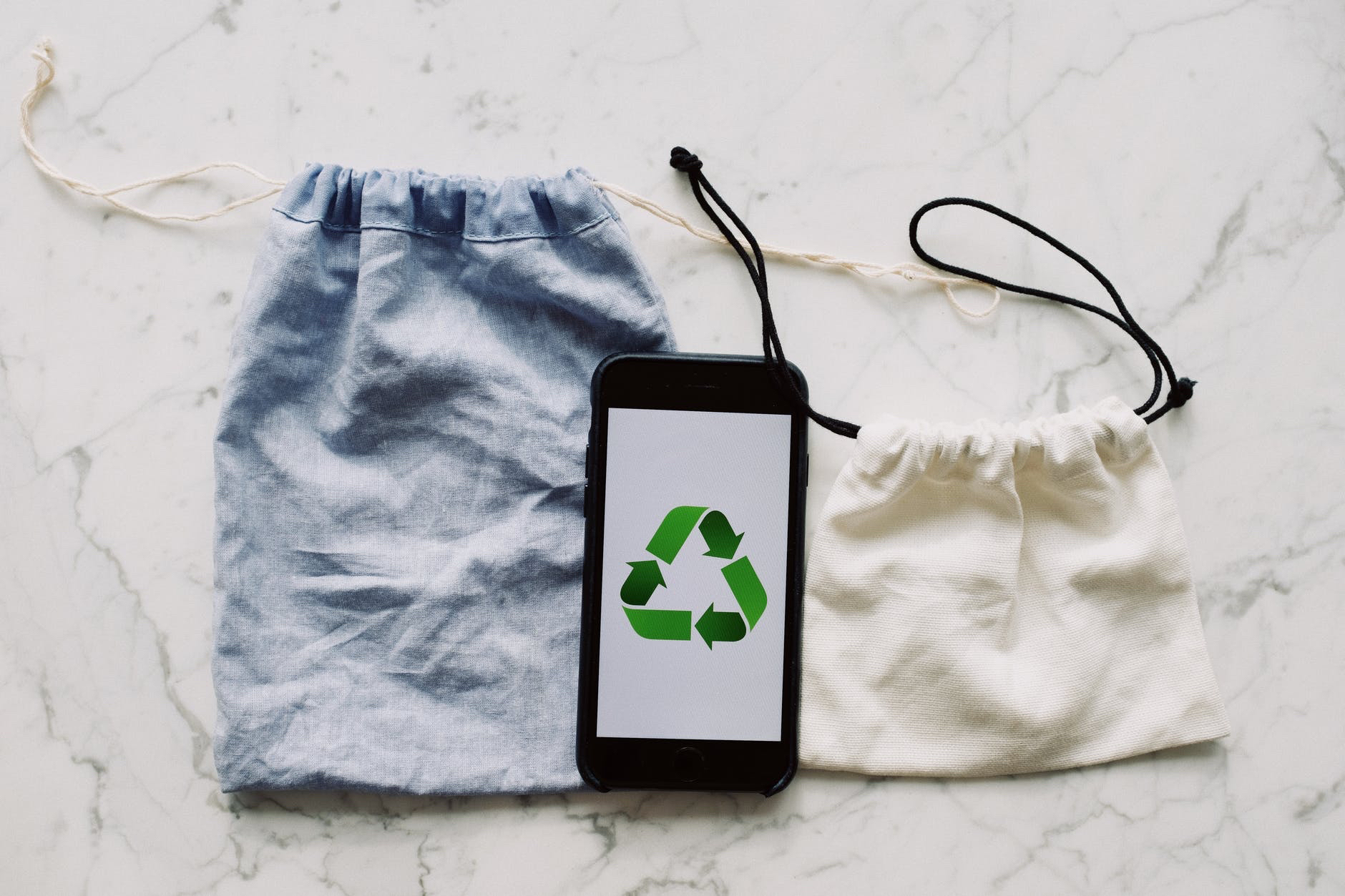 Image of cell phone with recycling symbol .