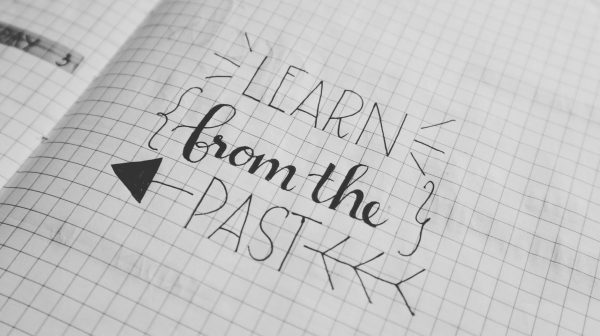Learn from the past written in notebook