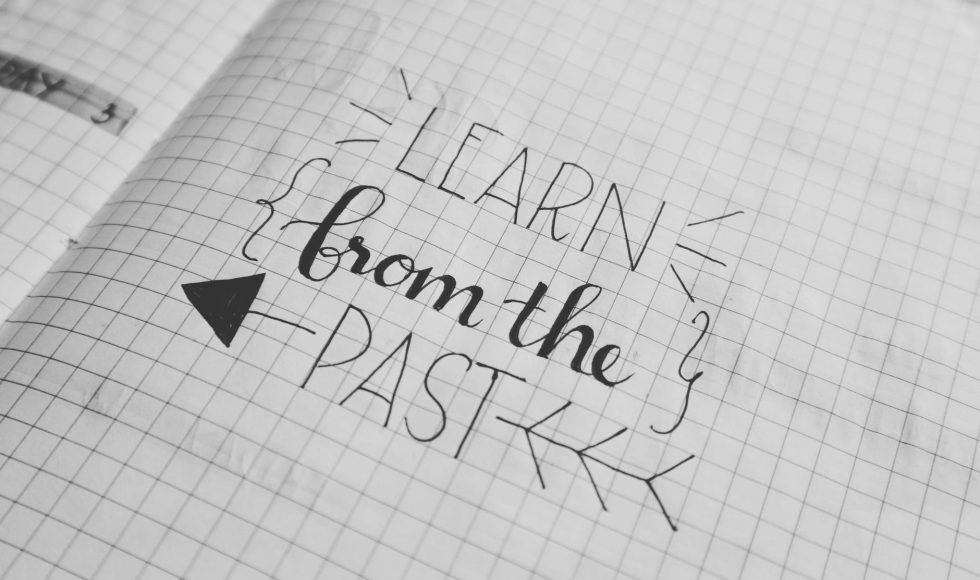 Learn from the past written in notebook