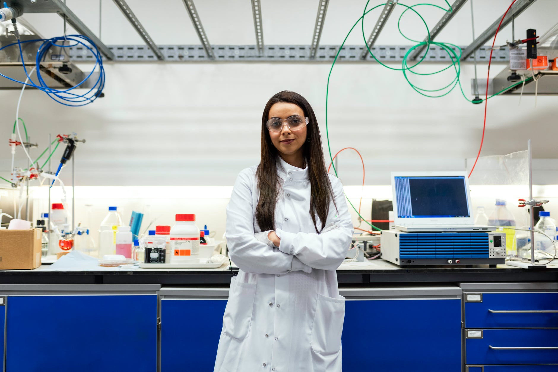 Female scientist leaning on lab bench