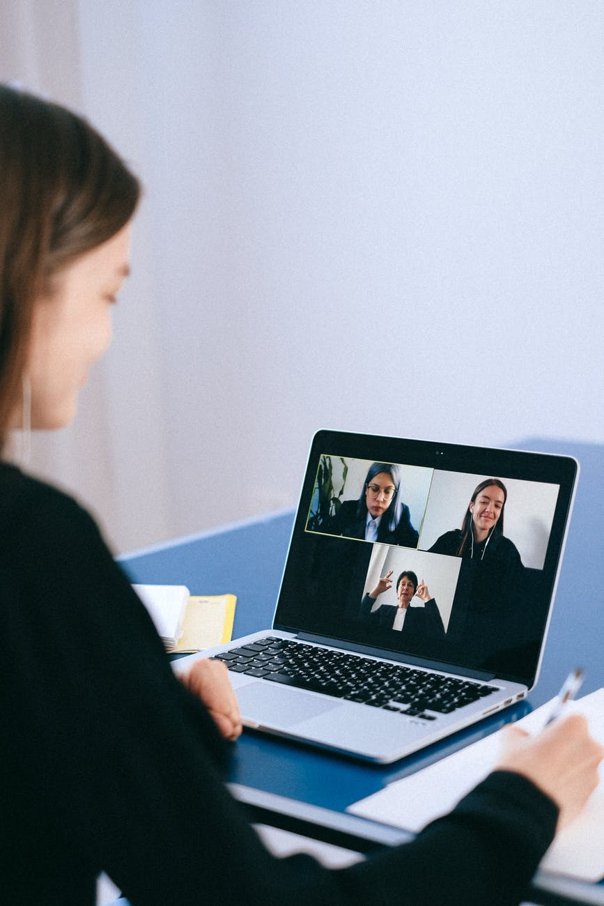 Sustainable educational videos and effective breakout rooms. People I’m video conference on laptop screen and using computer.