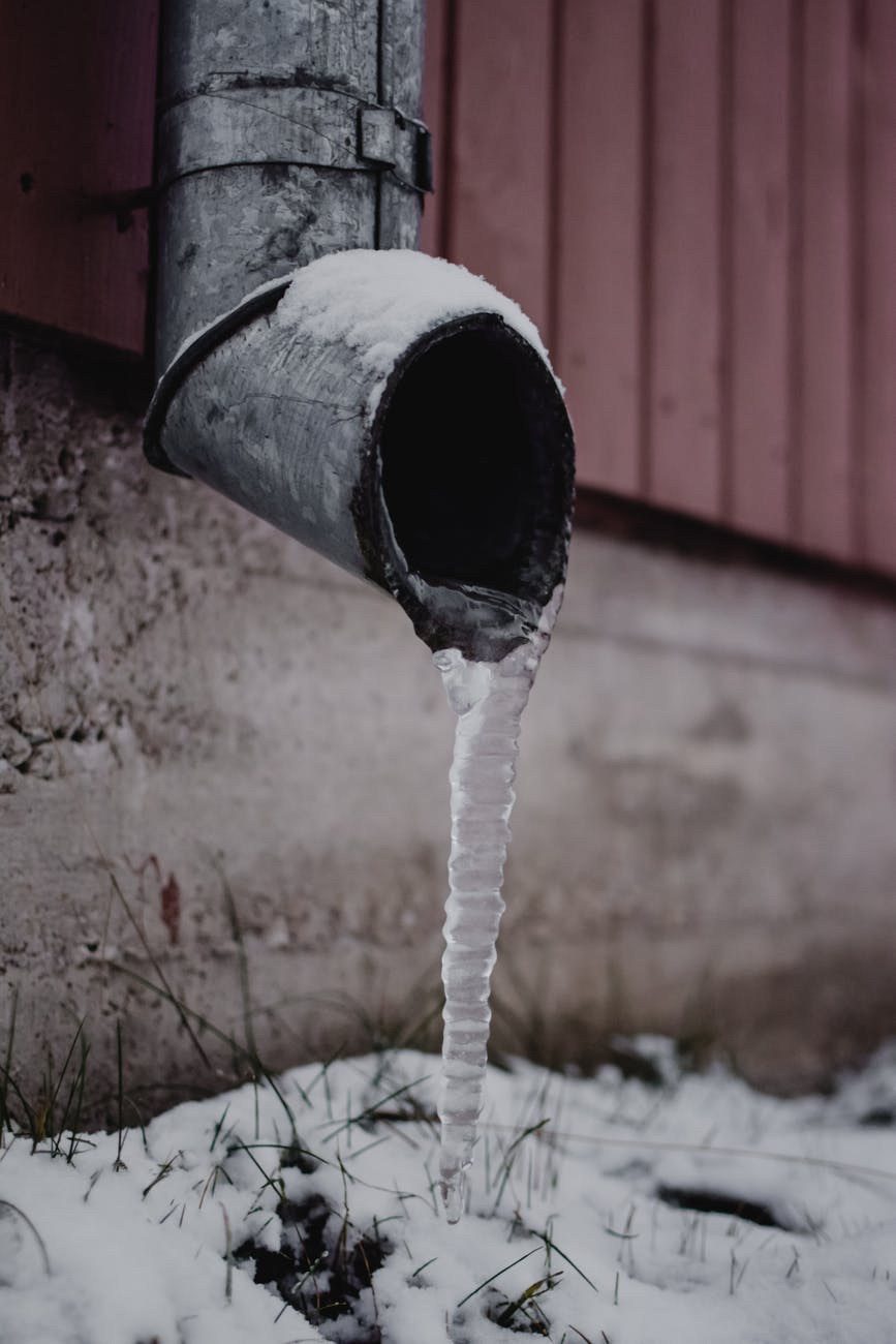 Downspout and frozen water and snow.