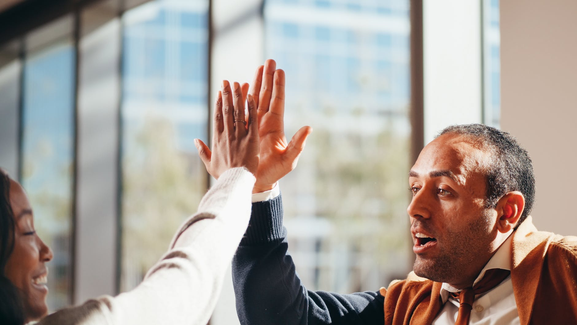 Photo of high five. One man is visible.