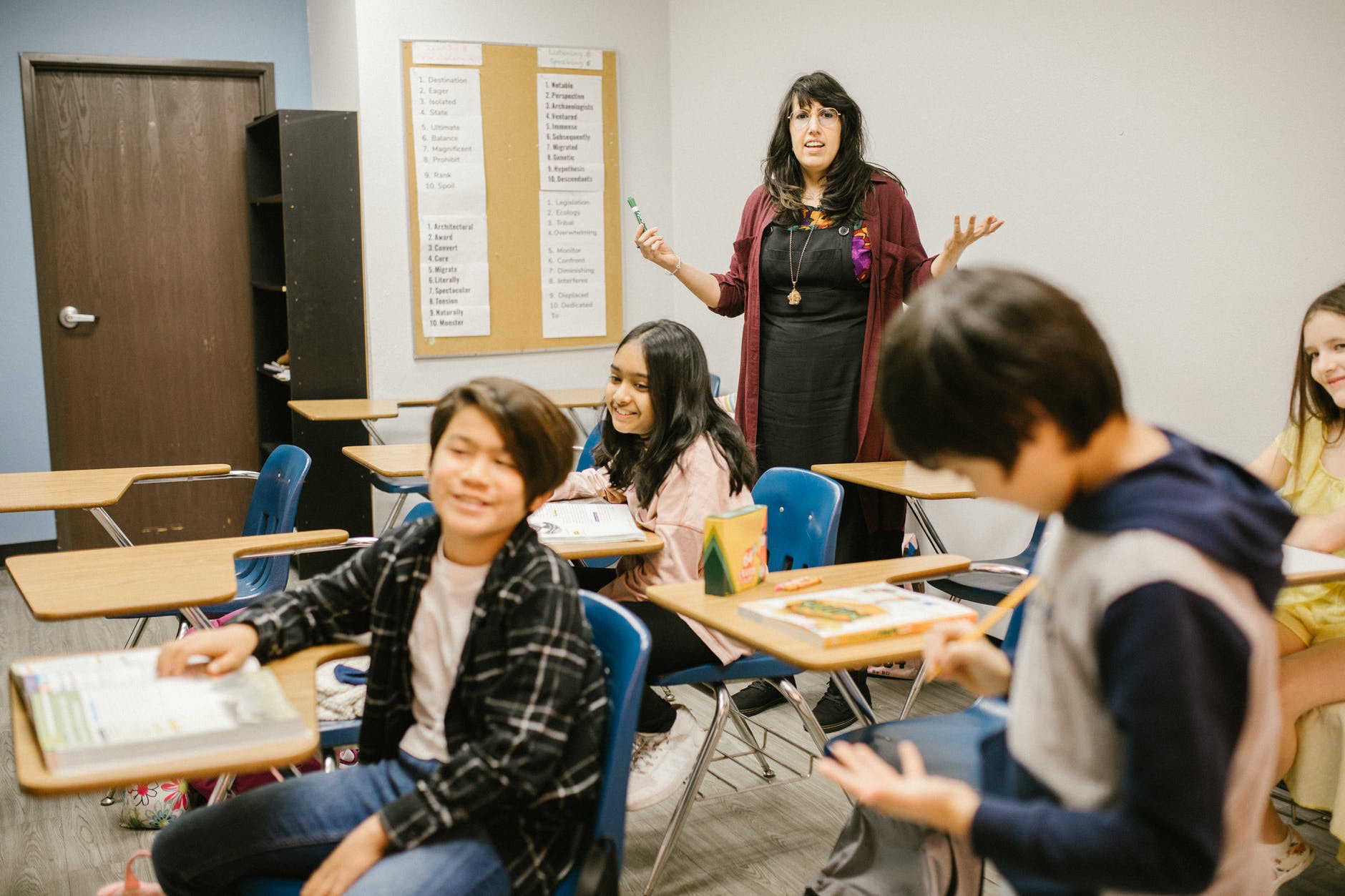 Classroom with elementary students at desks and teacher.