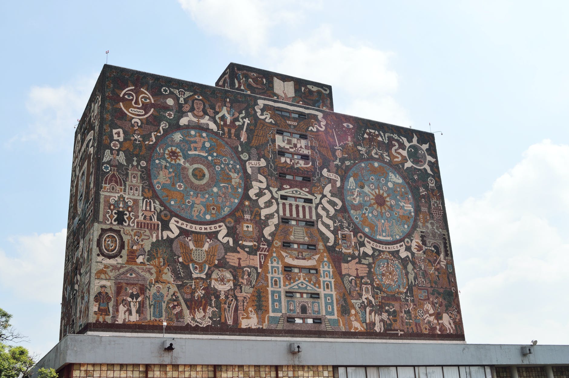 Building with decorative images from the library at the UNAM in Mexico.