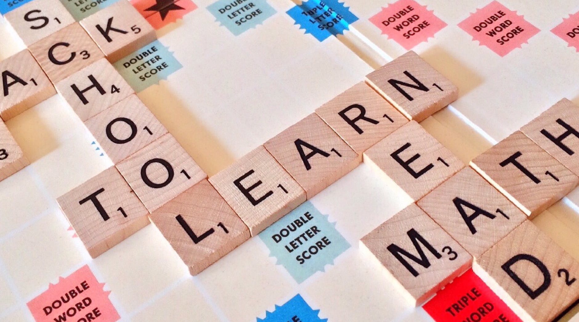Scrabble board with the words:
School - vertically displayed
to - horizontally using second "o" from school
learn - horizontally using "l" from school
read - vertically using "r" from learn
math - horizontally using "a" from read.