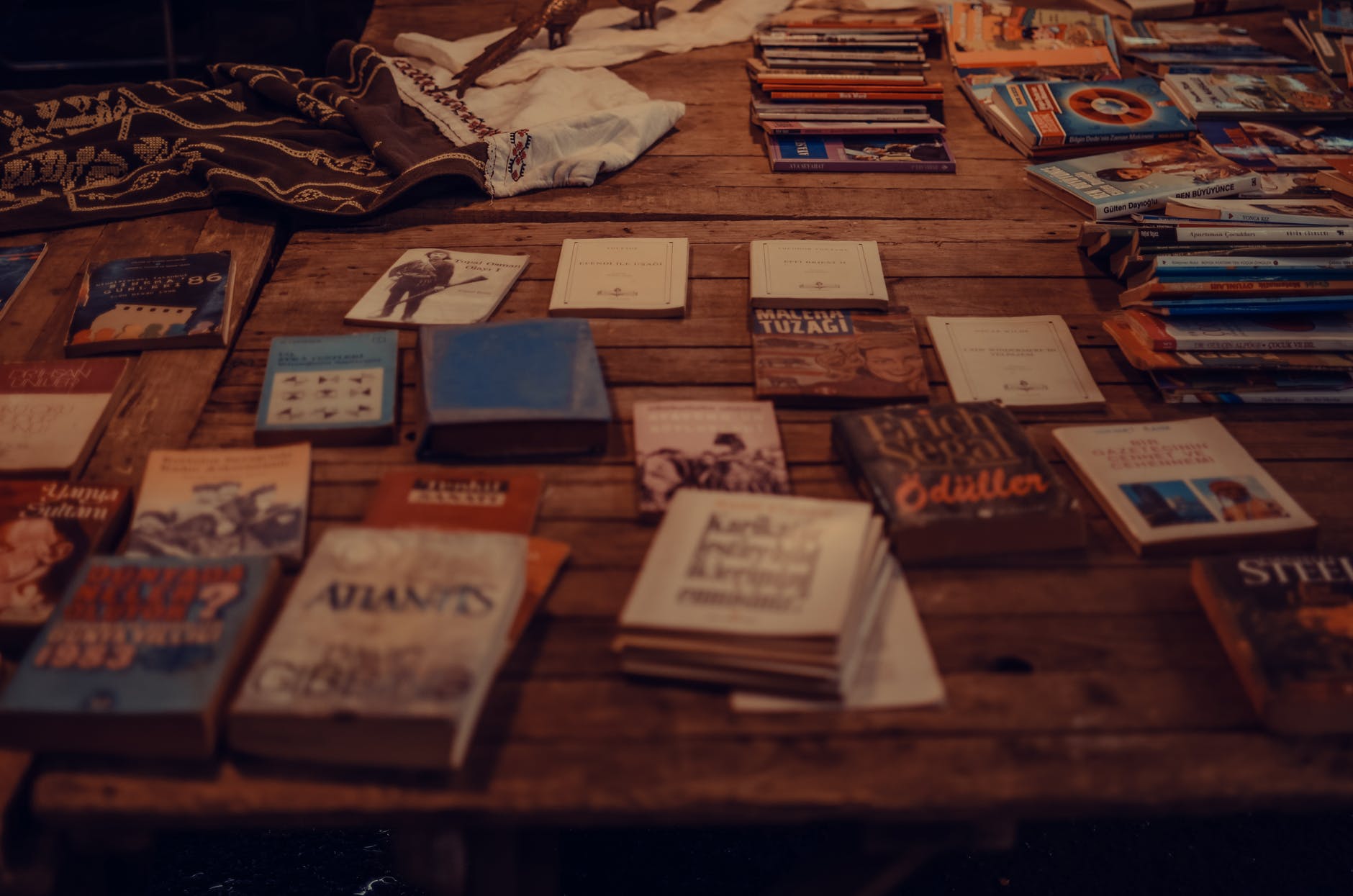 Table with dozens of books spread out.
