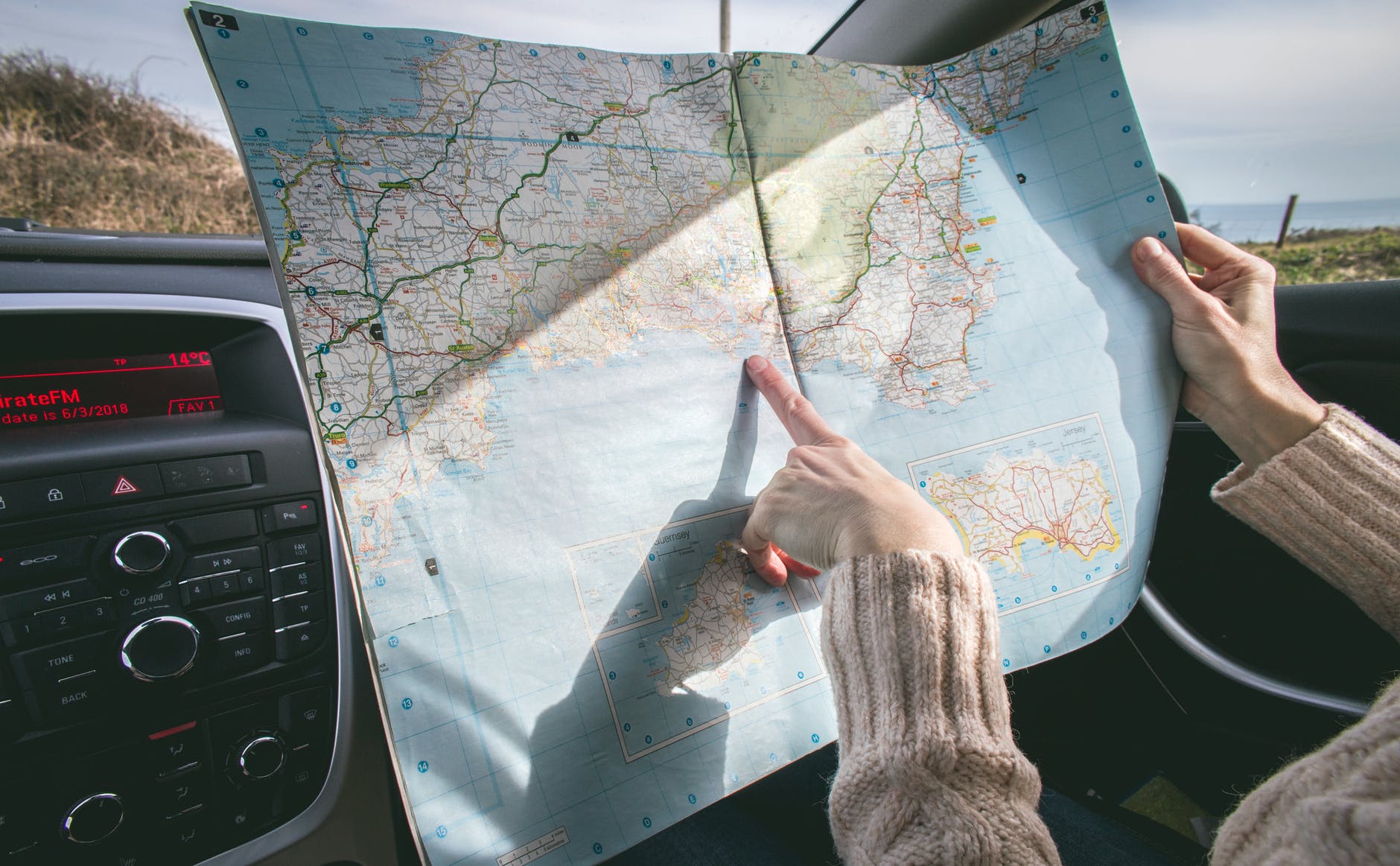 paper roadmap and finger point to location