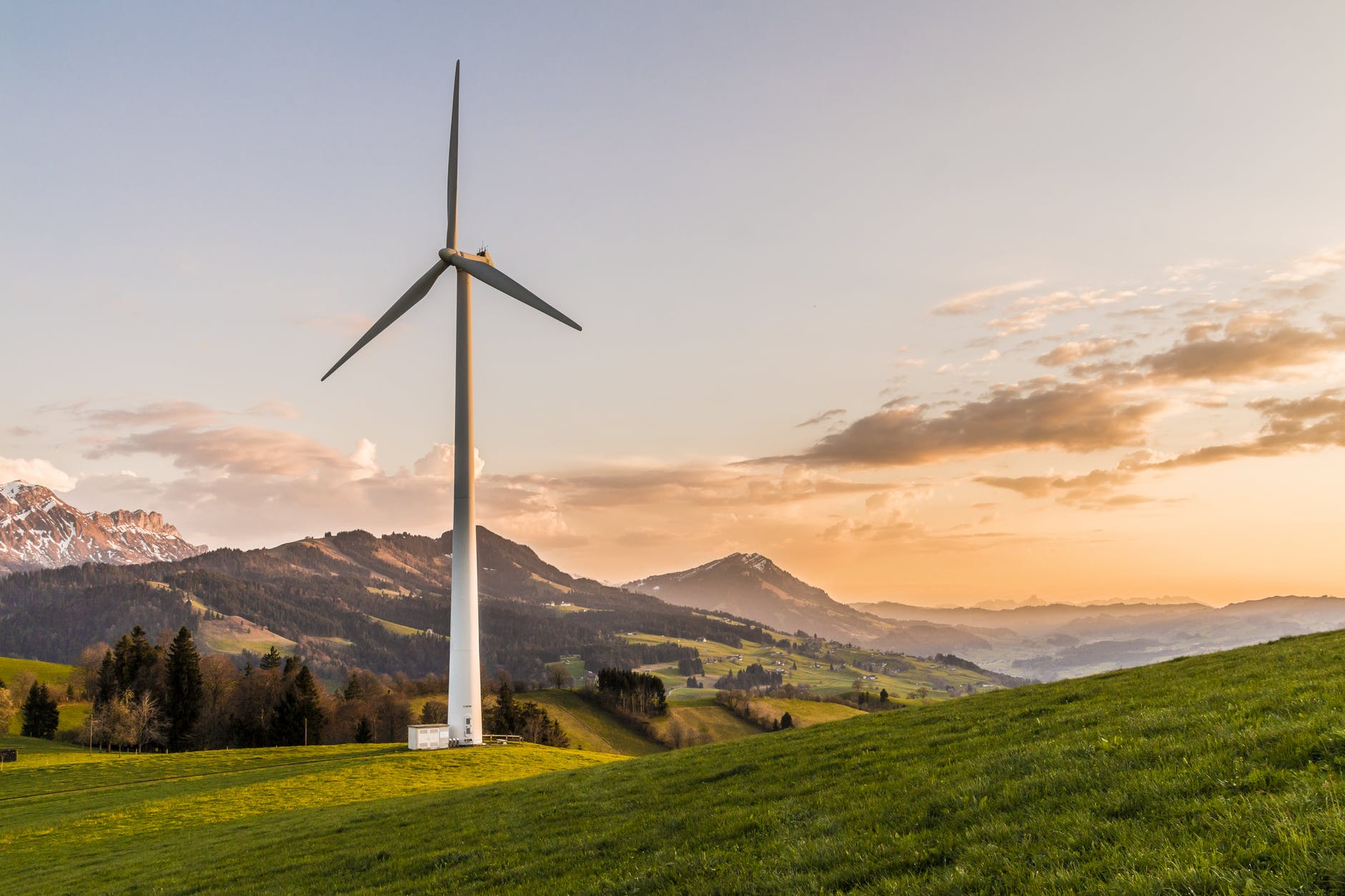 Landscape with wind turbine and sunset.