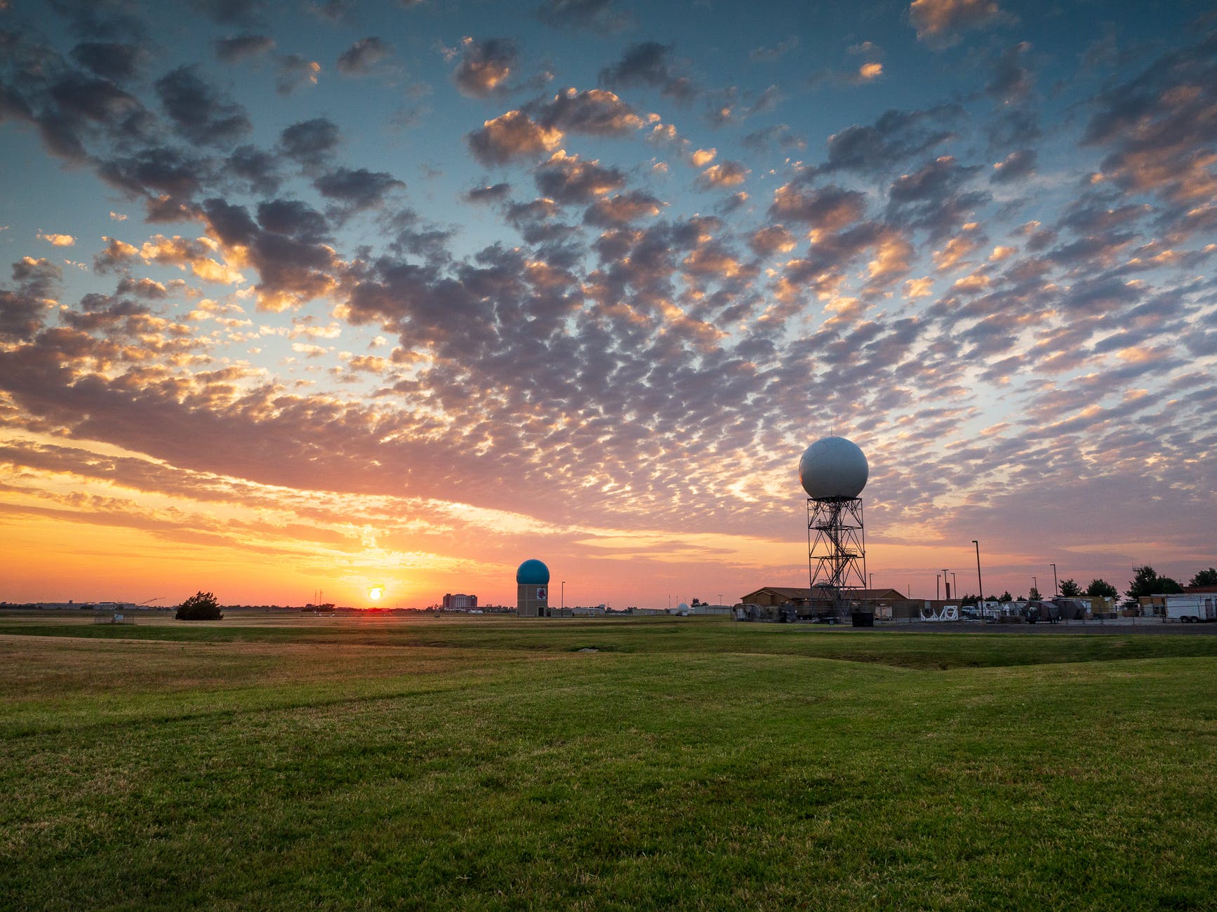 Green grass field under dawn sky in Norman Oklahoma.