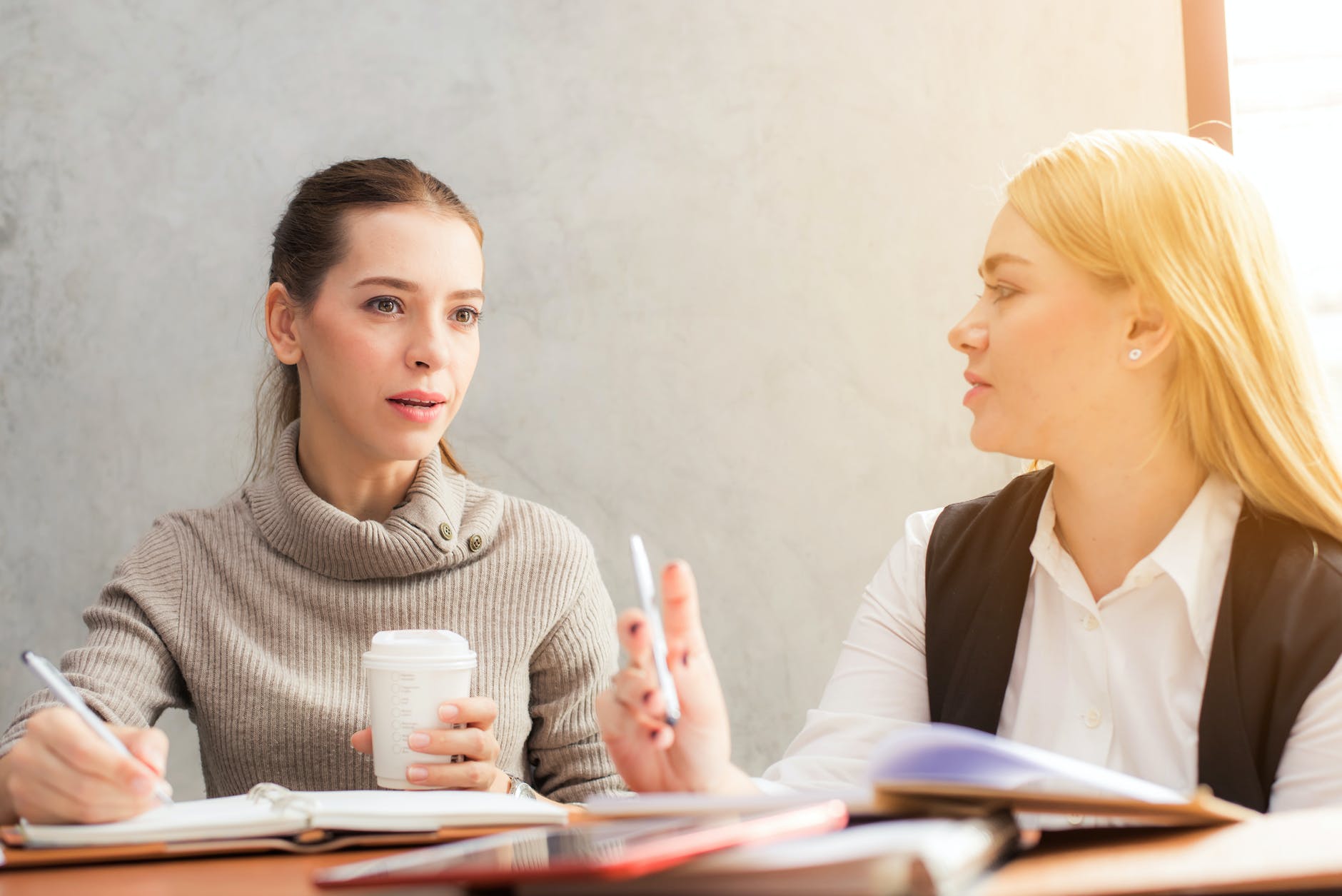 two white women talking to each other.
