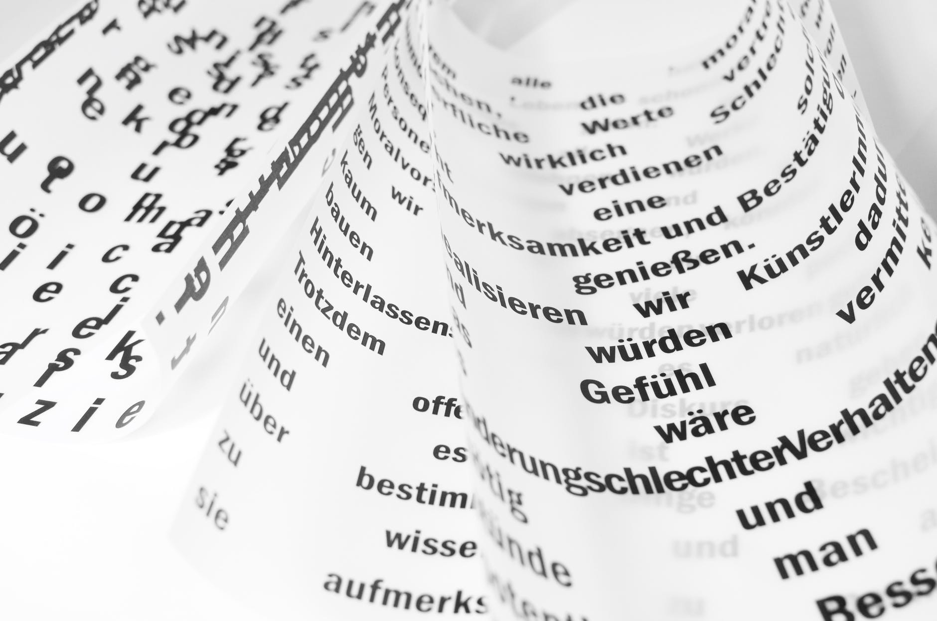 words on curled paper in different languages
