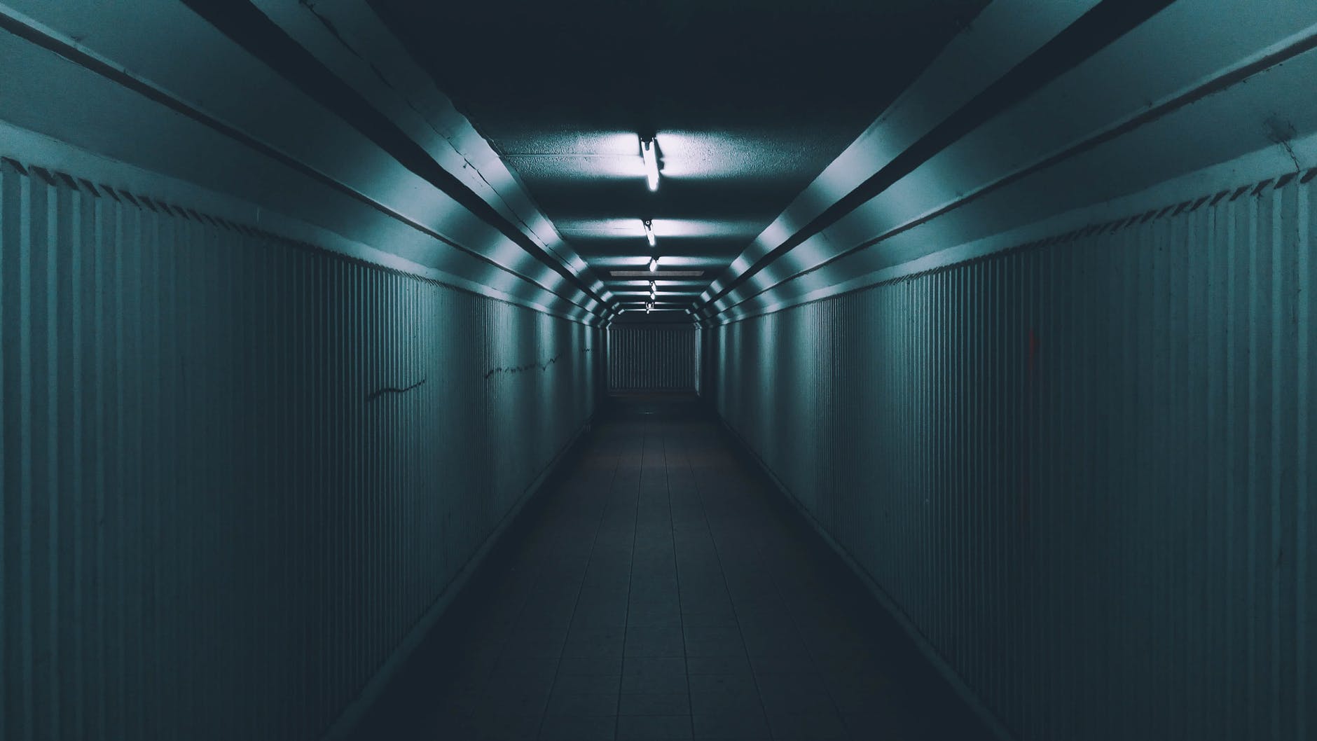 Dark hallway with overhead lights