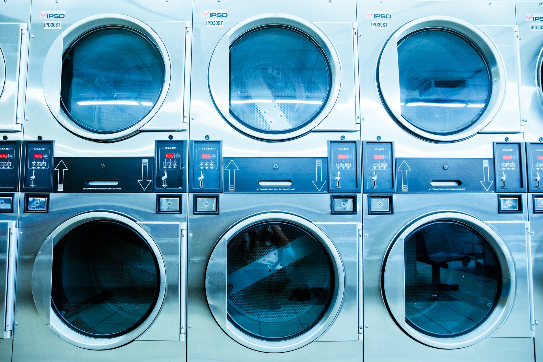 row of three washers in laundromat