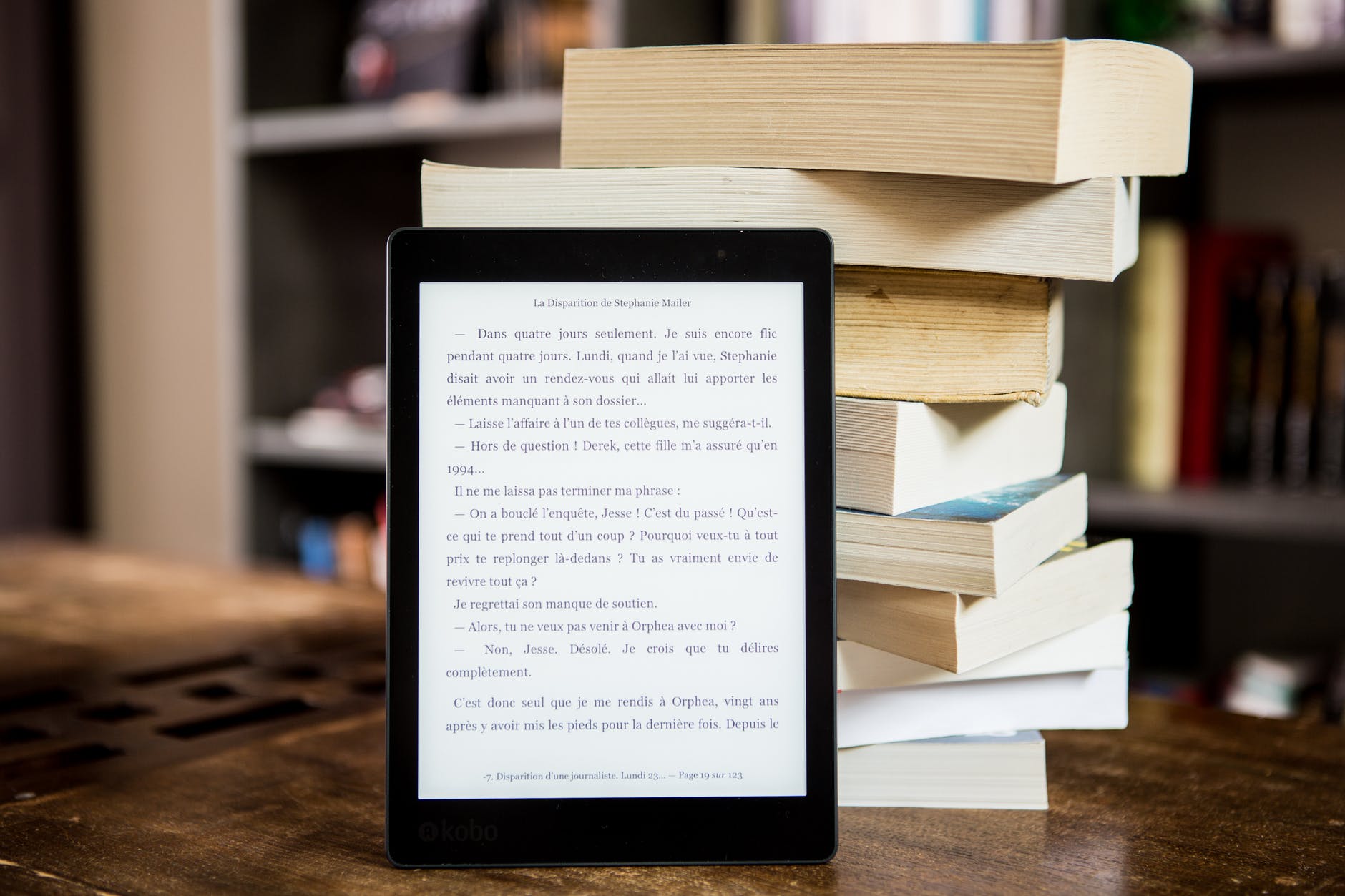 Tablet with text leaning on stack of books