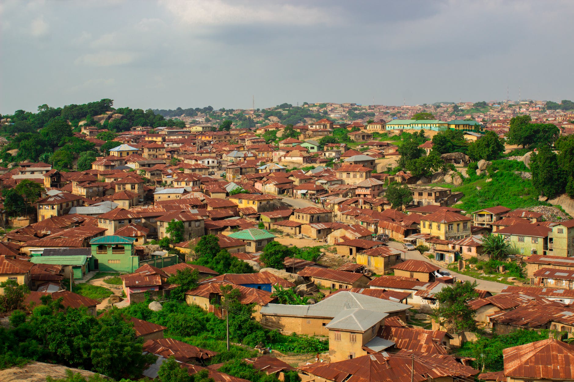 View of colorful yellow and green buildings with red roofs