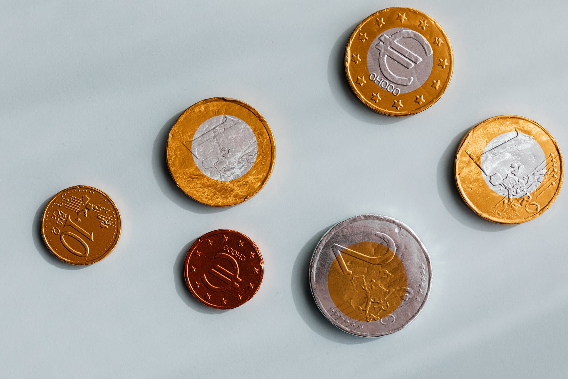 six coins in gold and silver metals