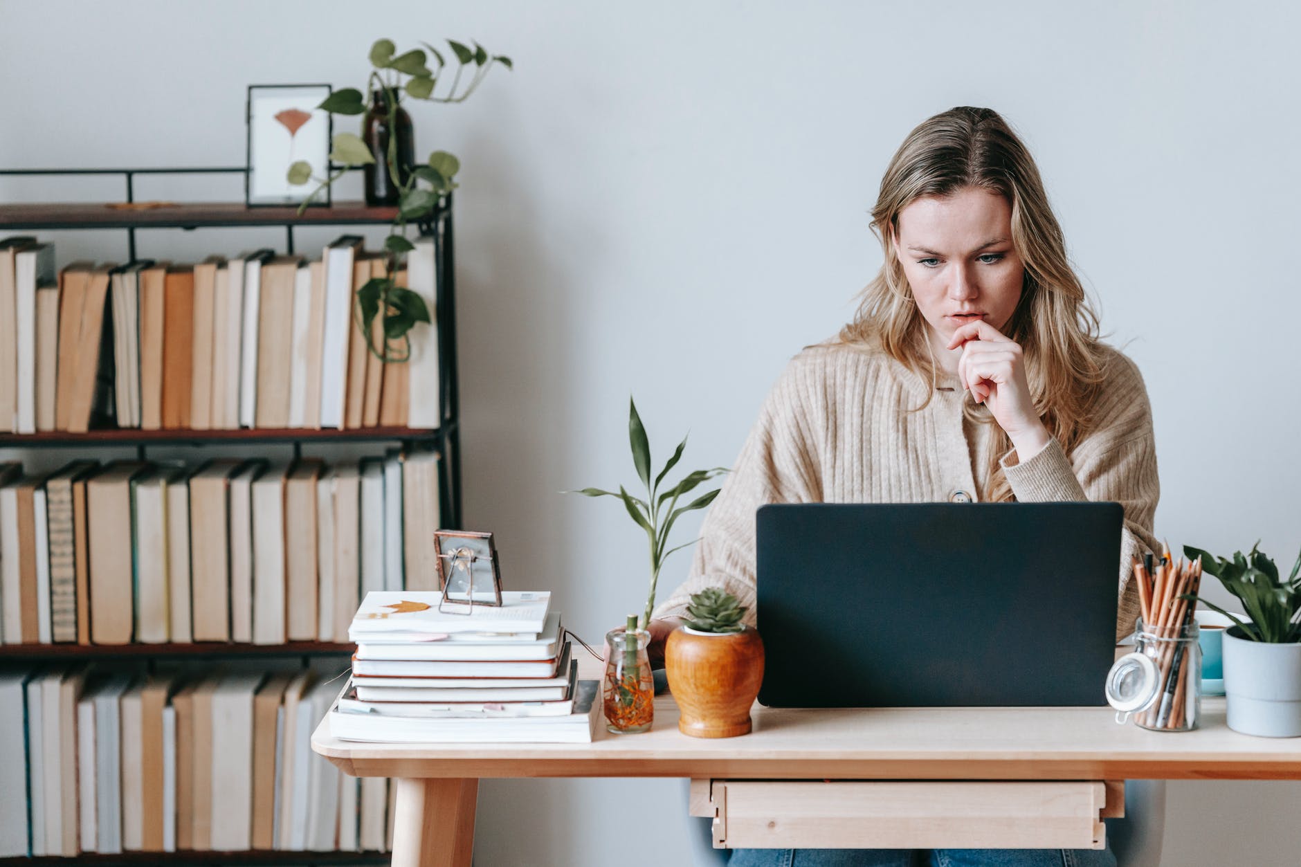 White woman at desk working on laptop