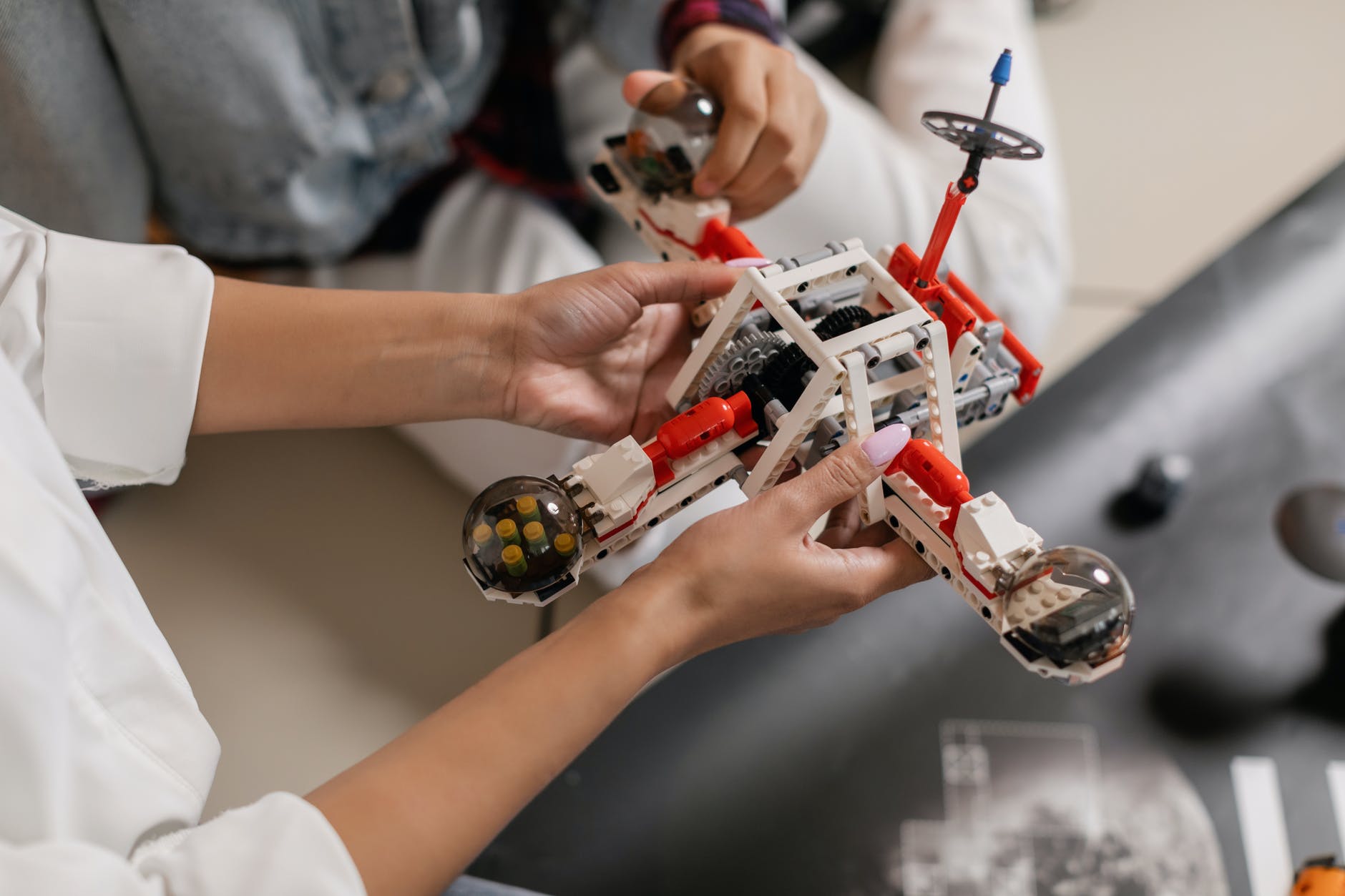 Hands holding Lego robots
