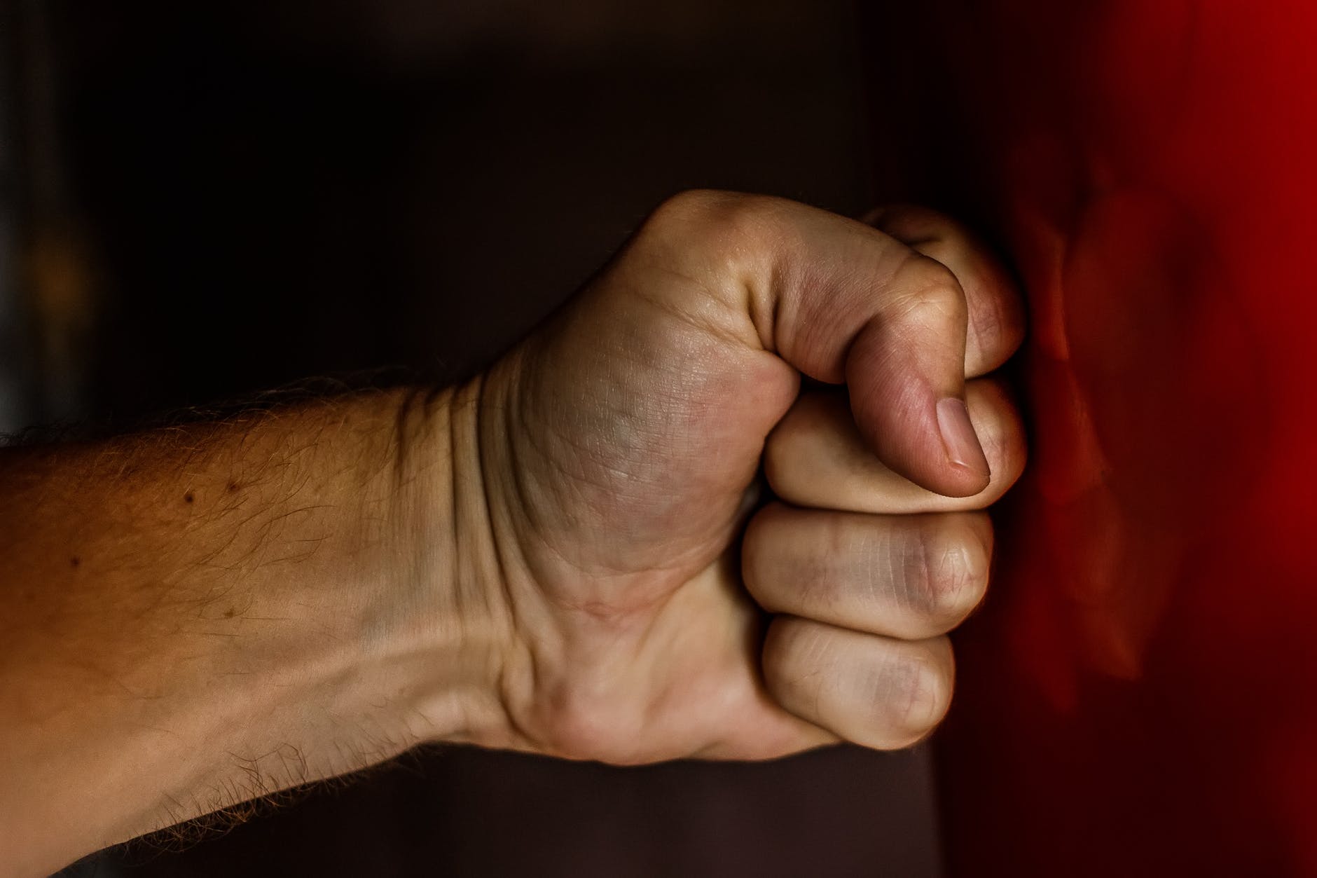 Clenched fist with darker skin tone