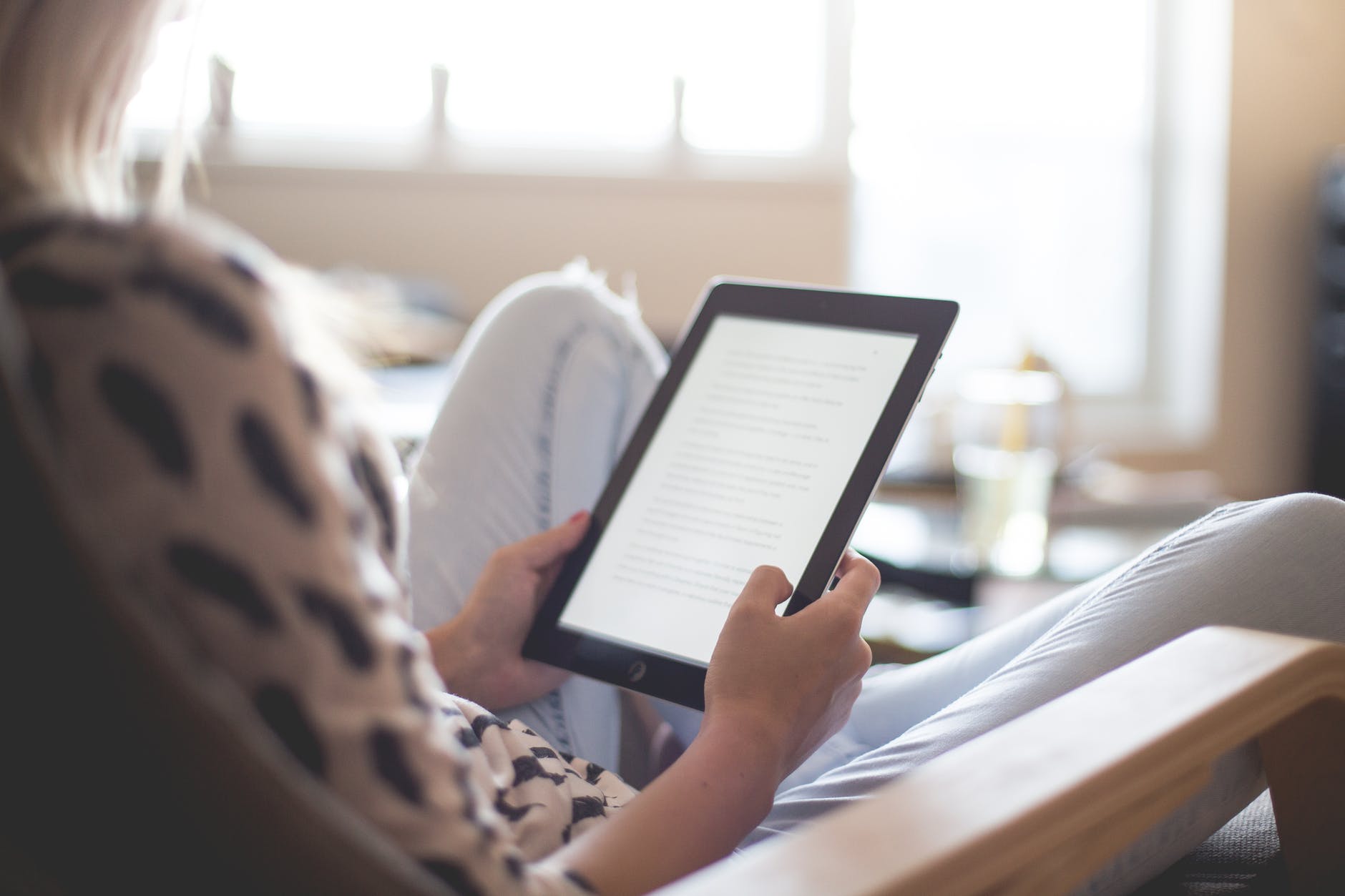 Person reading using a tablet