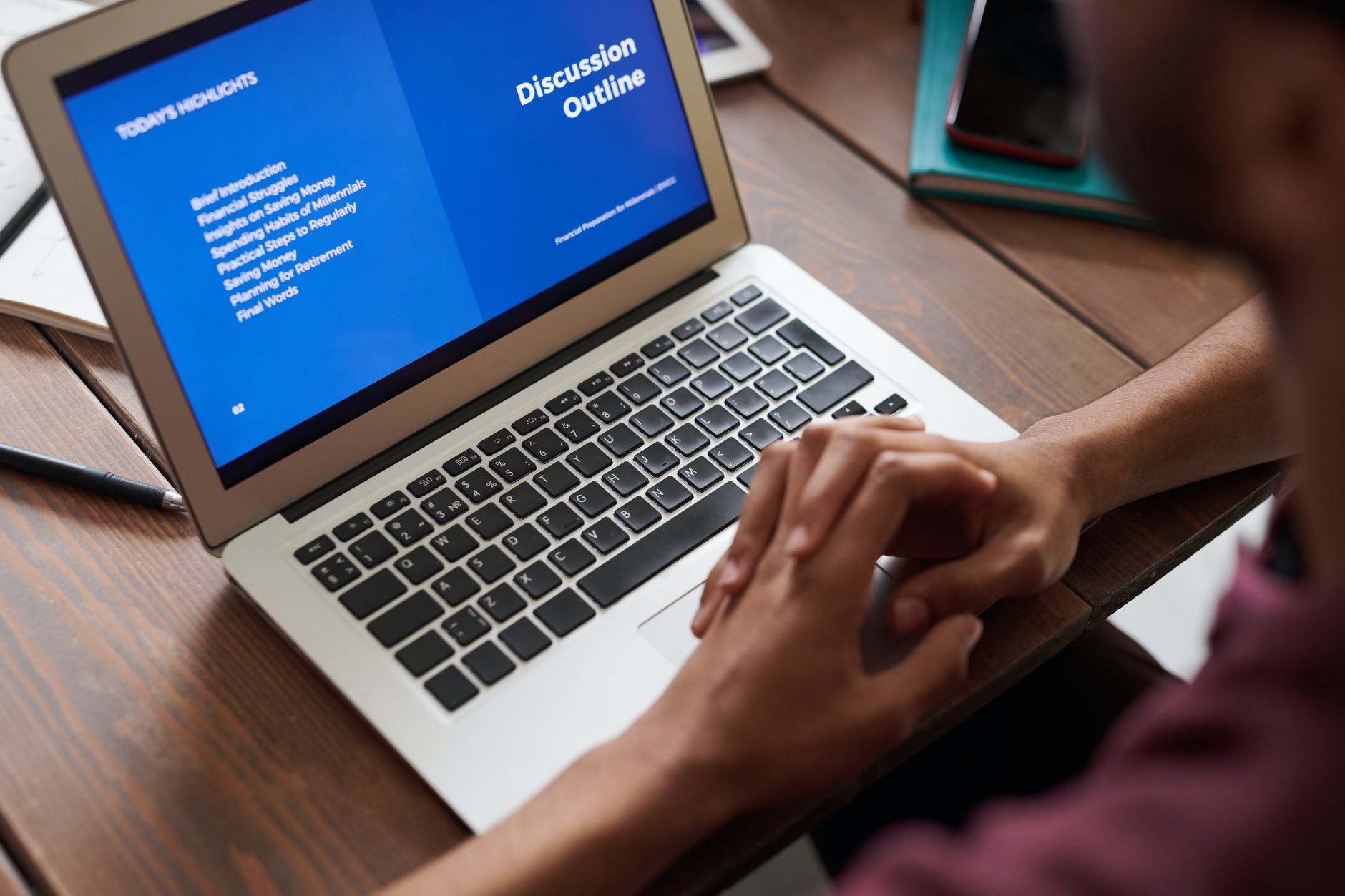 laptop with blue screen and "discussion outline" text in white