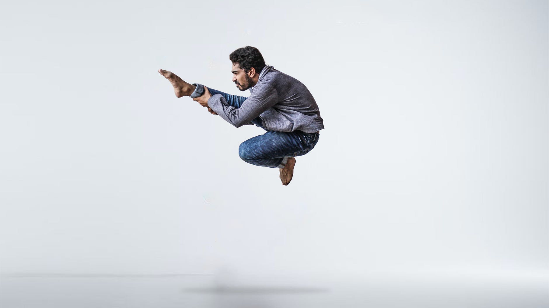 dancer leaping in the air with white background