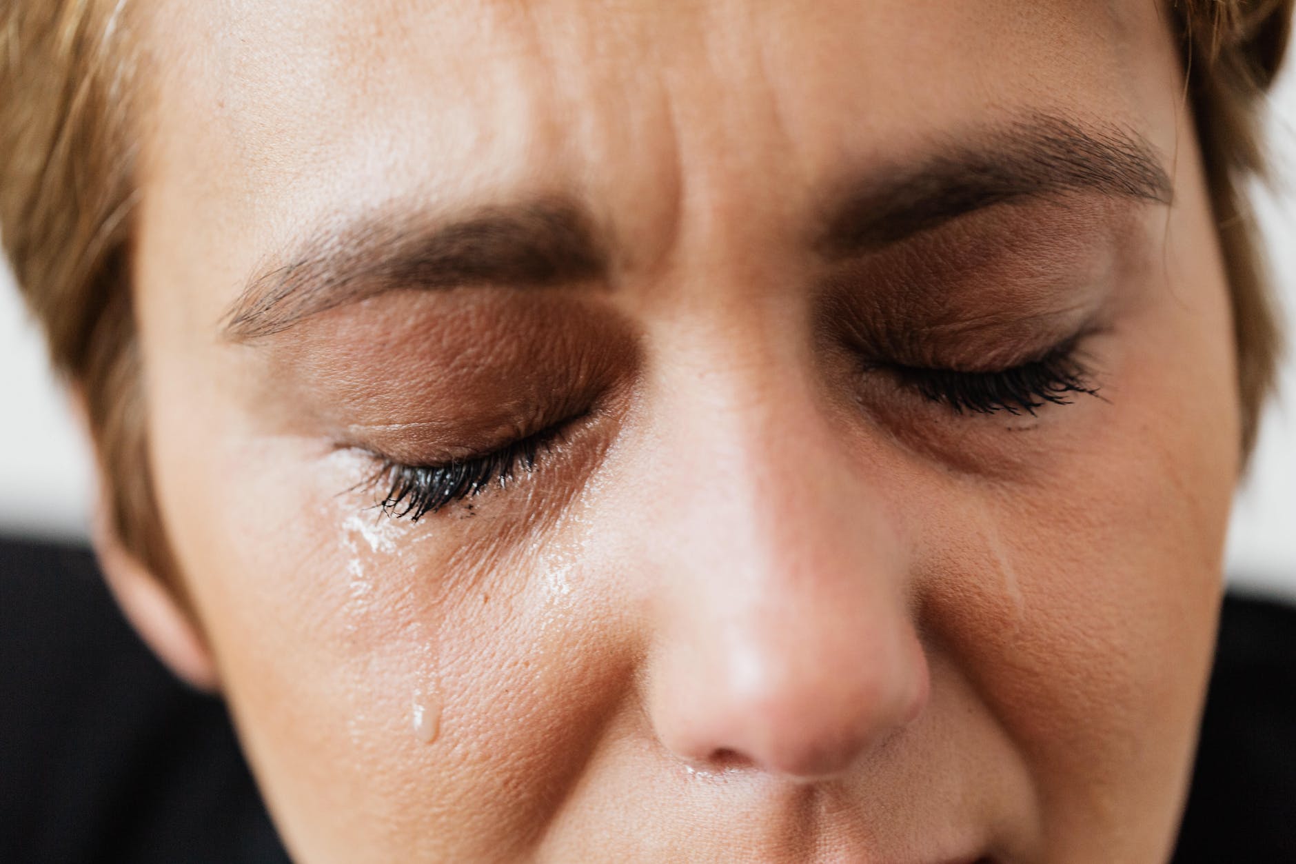 Woman with eyes closed and tears