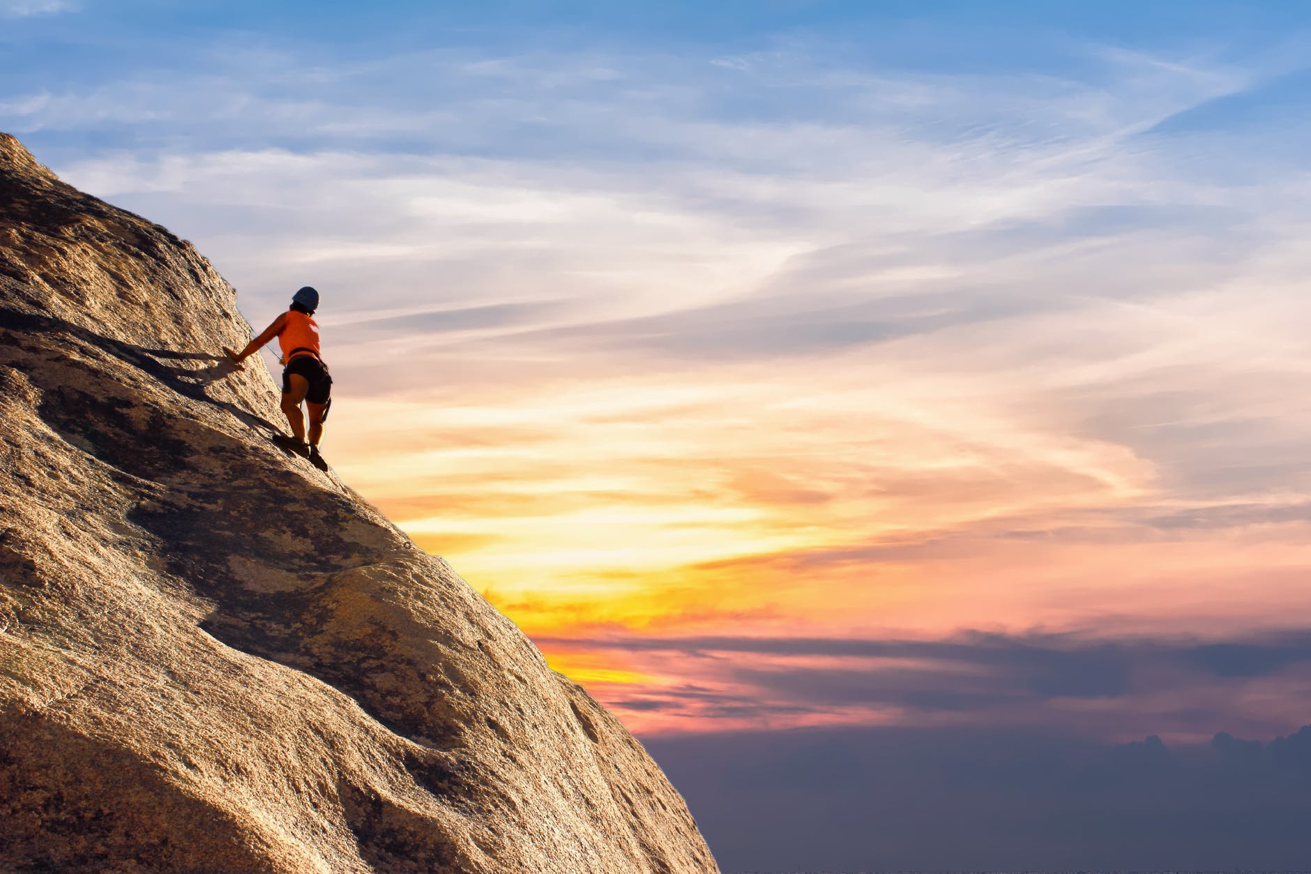 mountains and sunset with climber