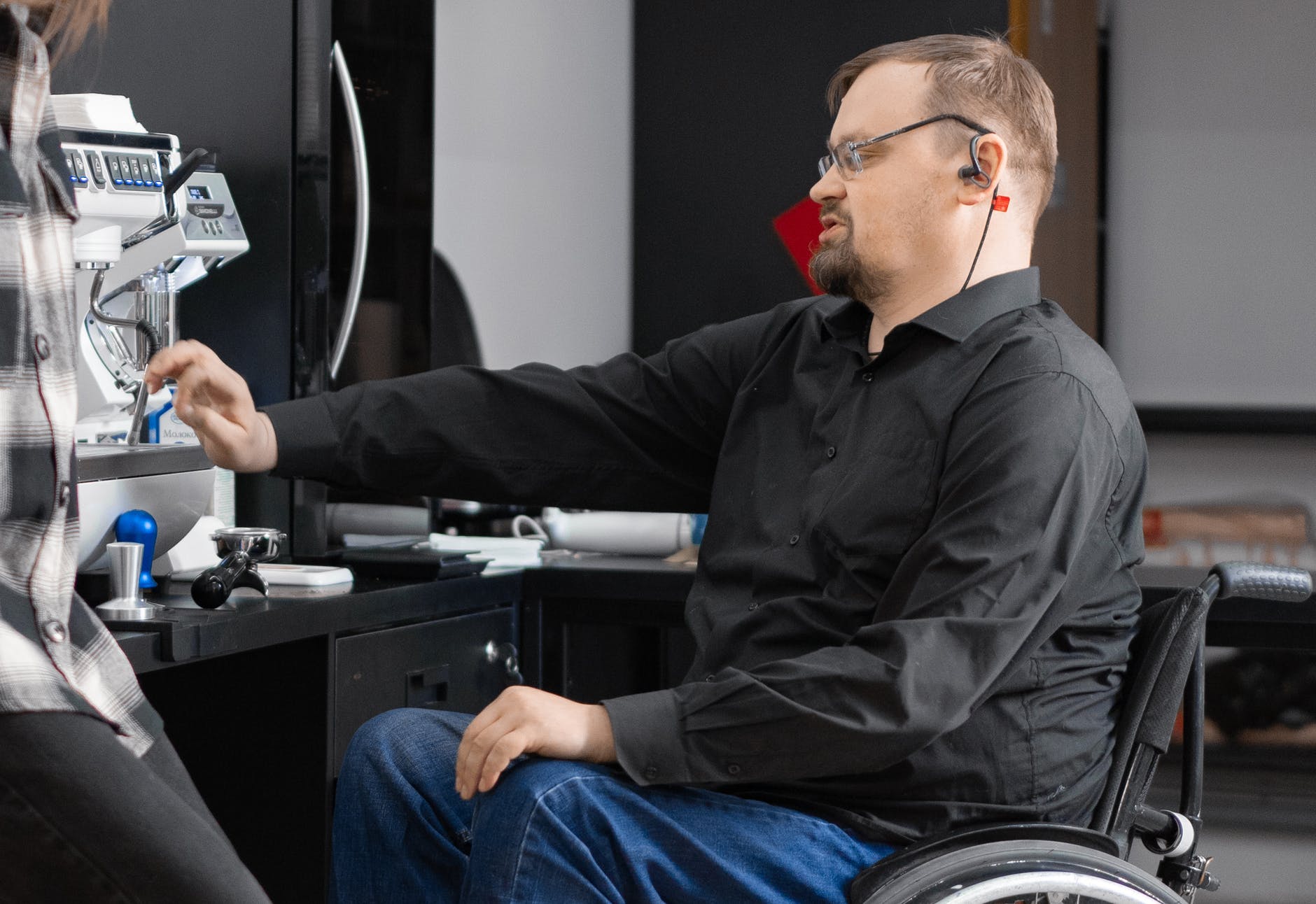 man in wheelchair in front of instrument