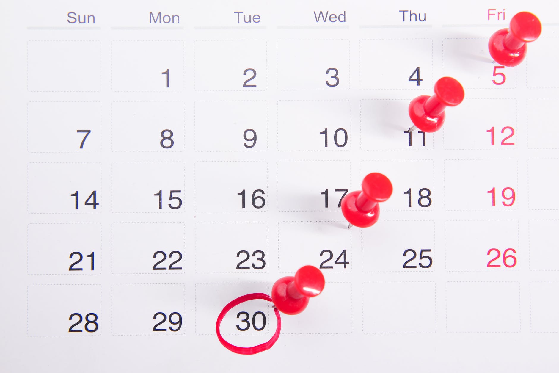 Calendar with red push pins every week on days 5, 11, 17, 30.