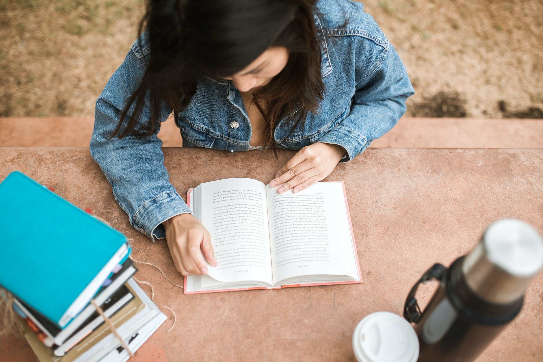 Person reading book at table