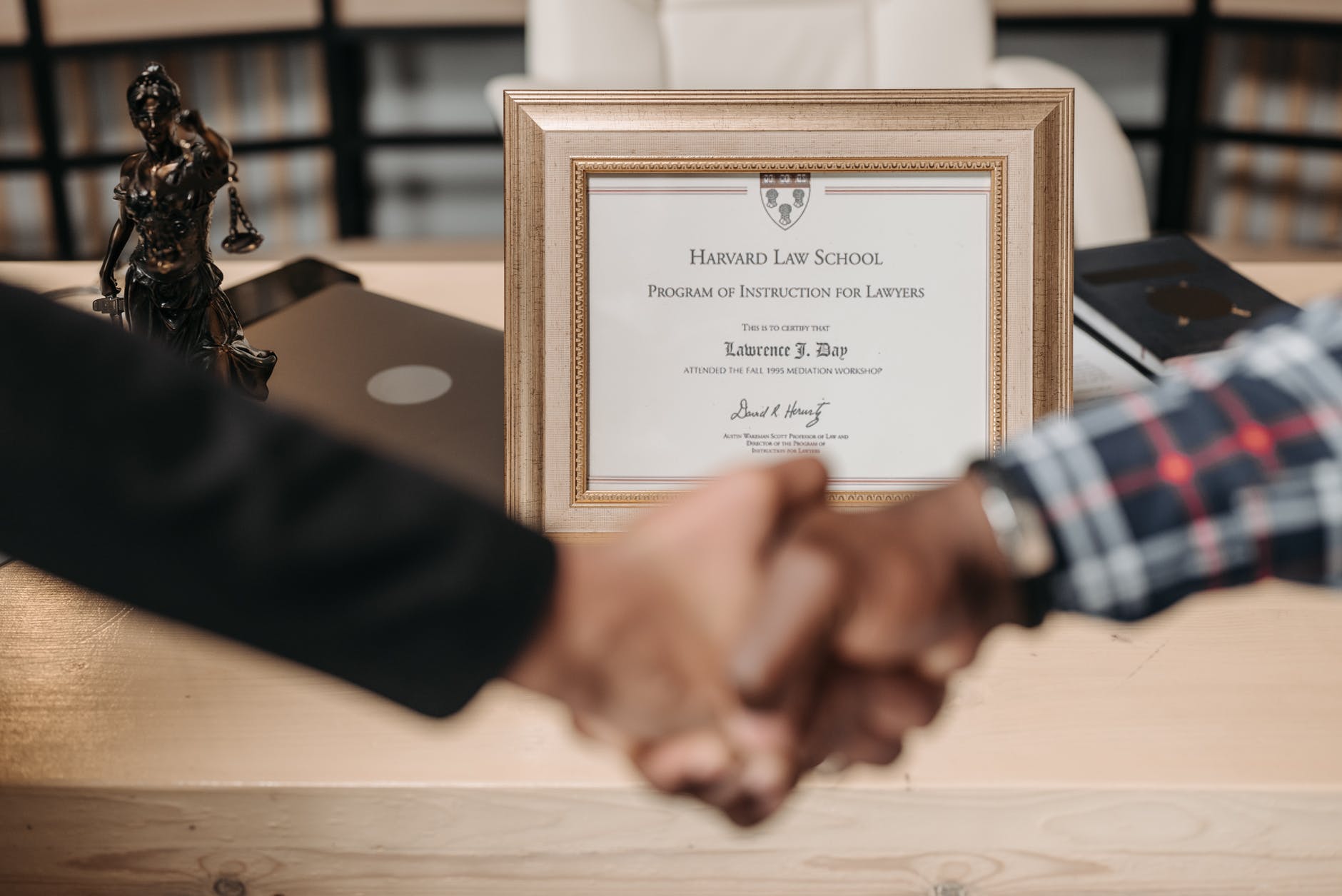 hands shaking next to certificate