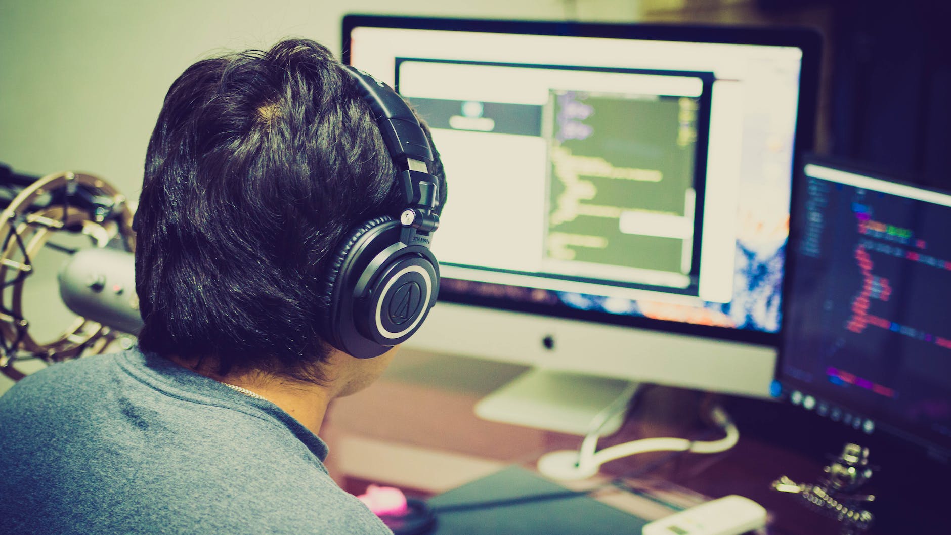 Student in front of computer wearing headphones