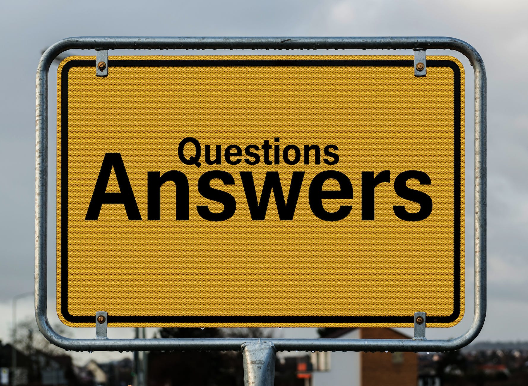 Yellow sign with black text: Questions Answers
Answers is much larger than questions.