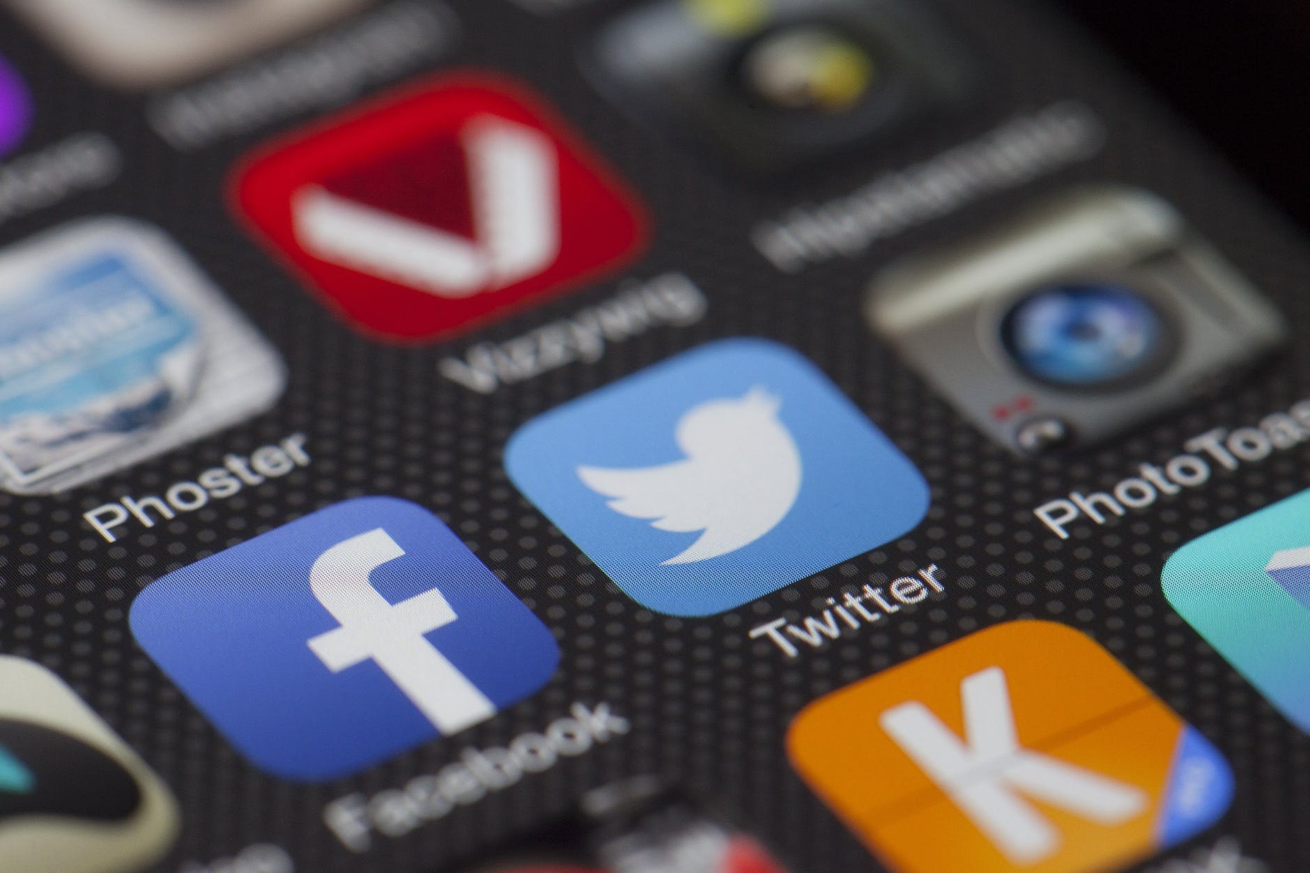 Apps on a device, including Twitter and Facebook icons.