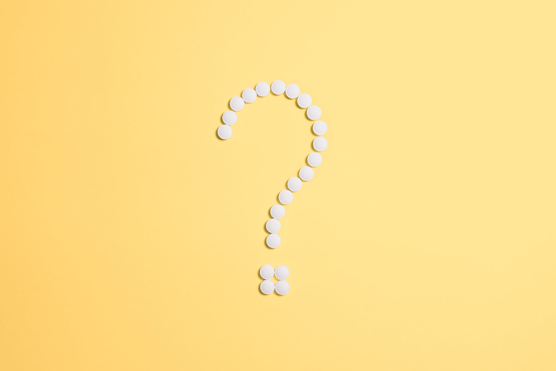 yellow background and question mark made with white beads