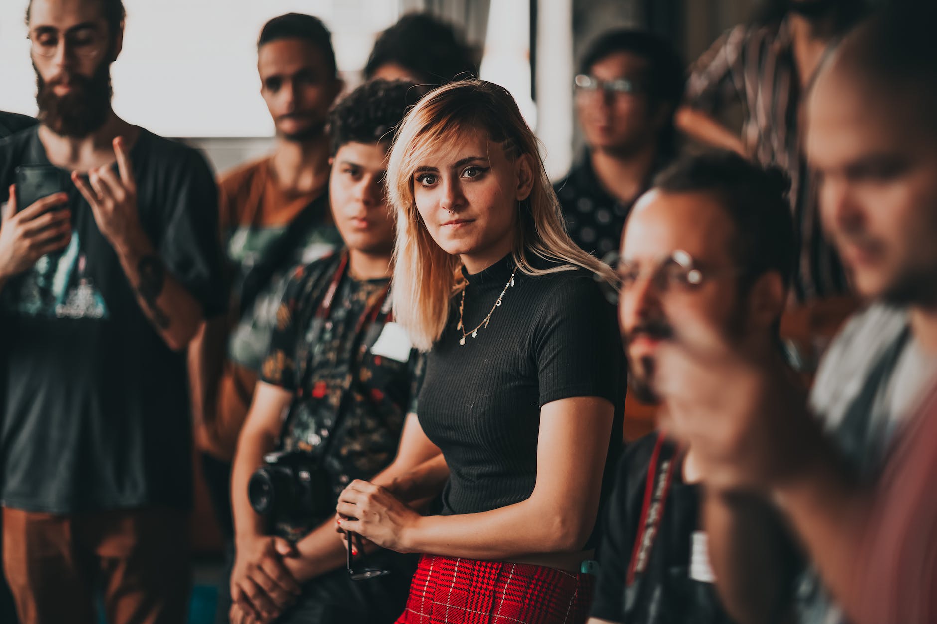 Group of people and focus on blond woman in middle