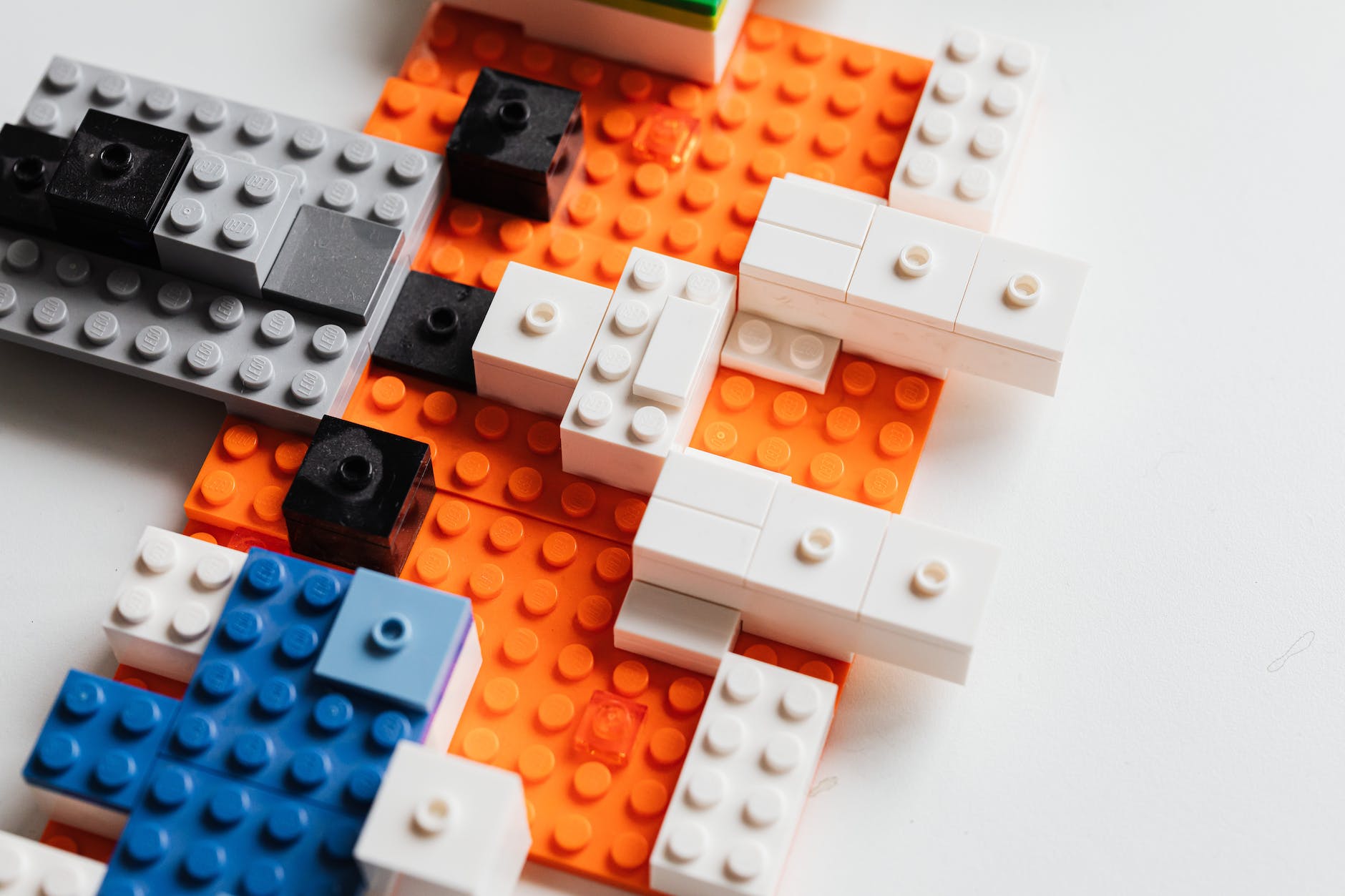 orange, black, gray, and white legos