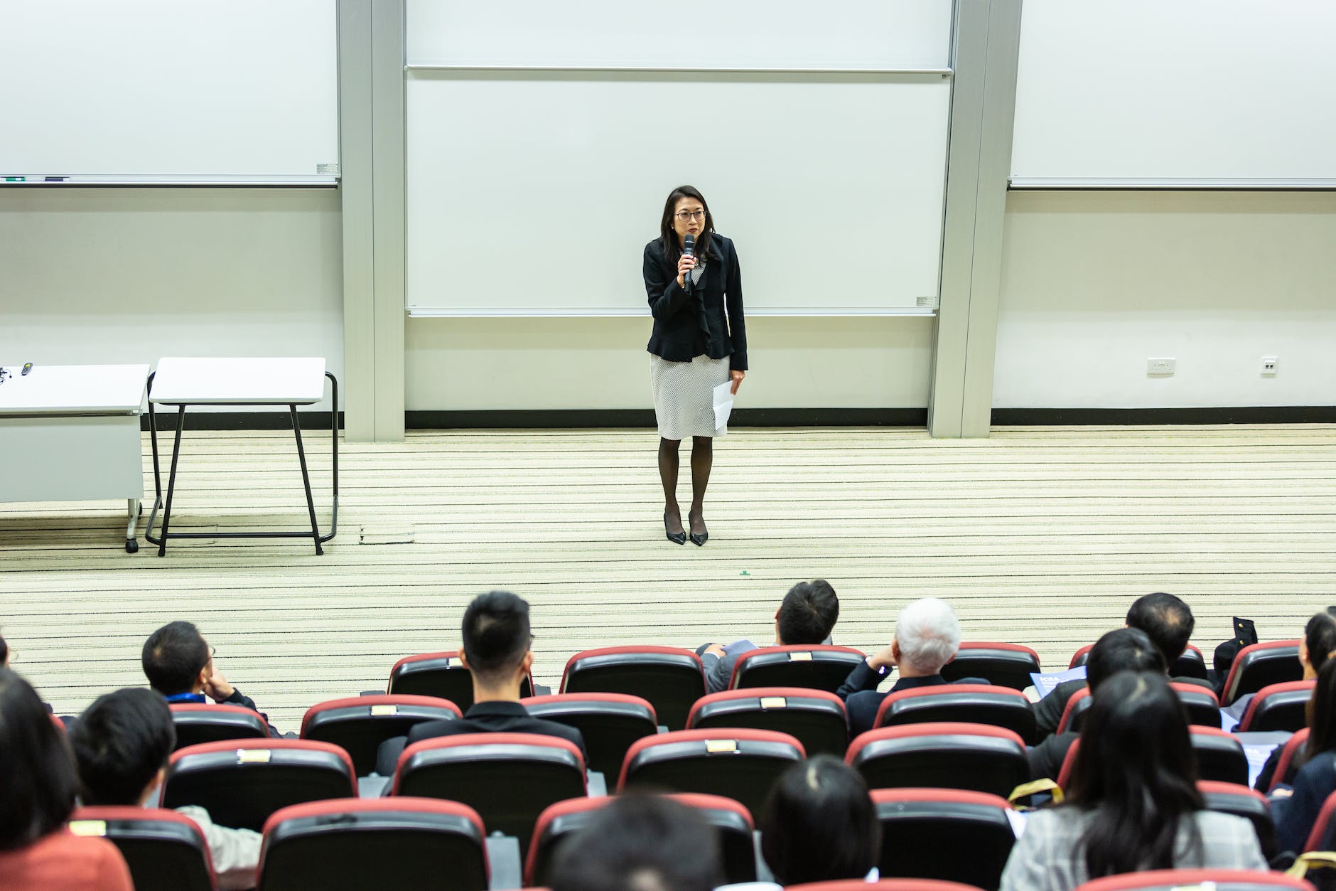 female instructor in front of audience in lecture hall