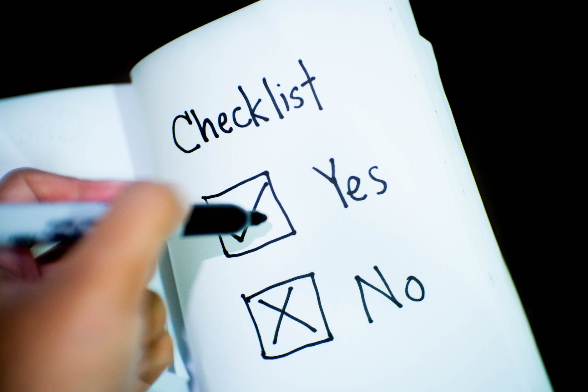 Checklist with yes no checkboxes and black marker over Yes.
