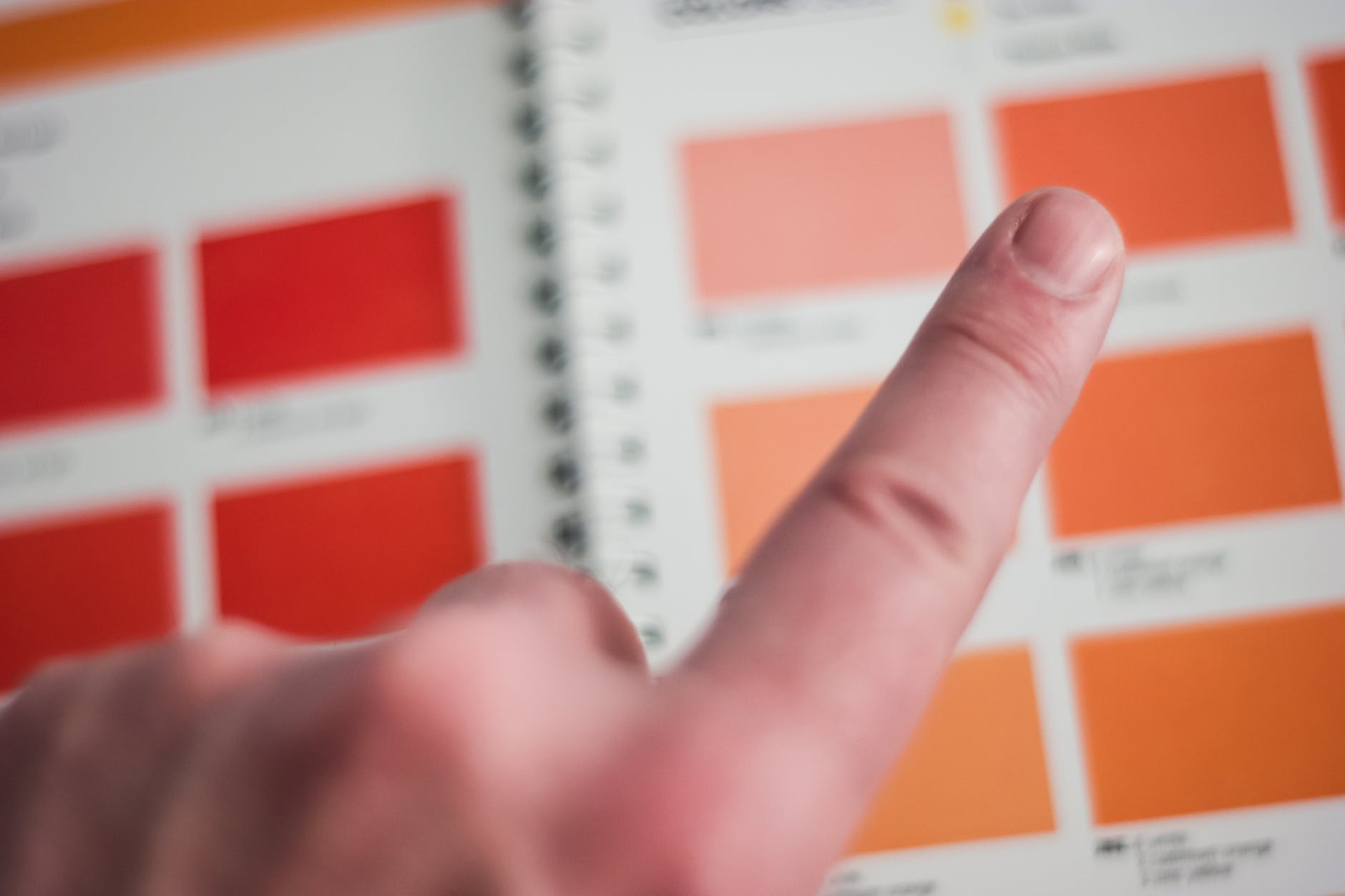 color palette and finger pointing to orange