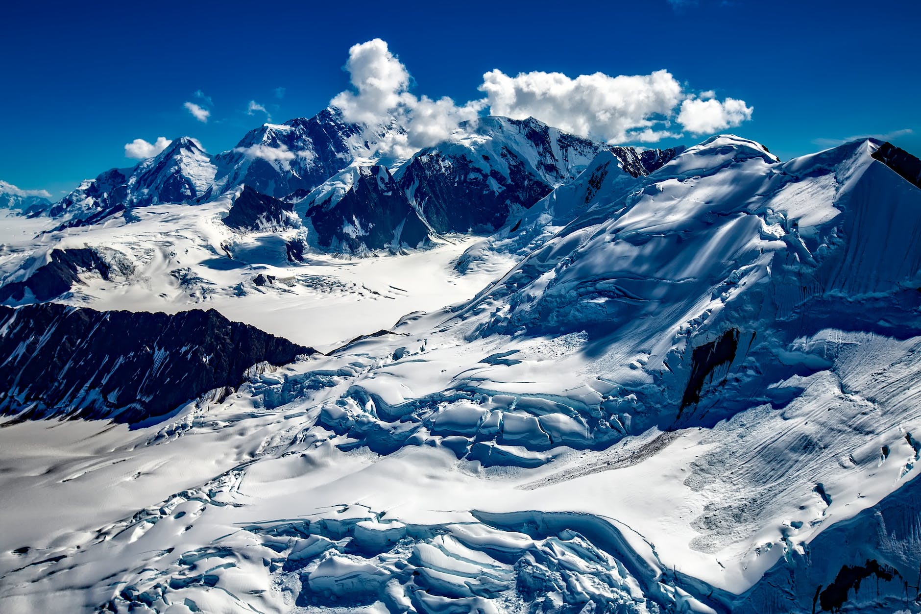 mountain covered with snow under blue sky