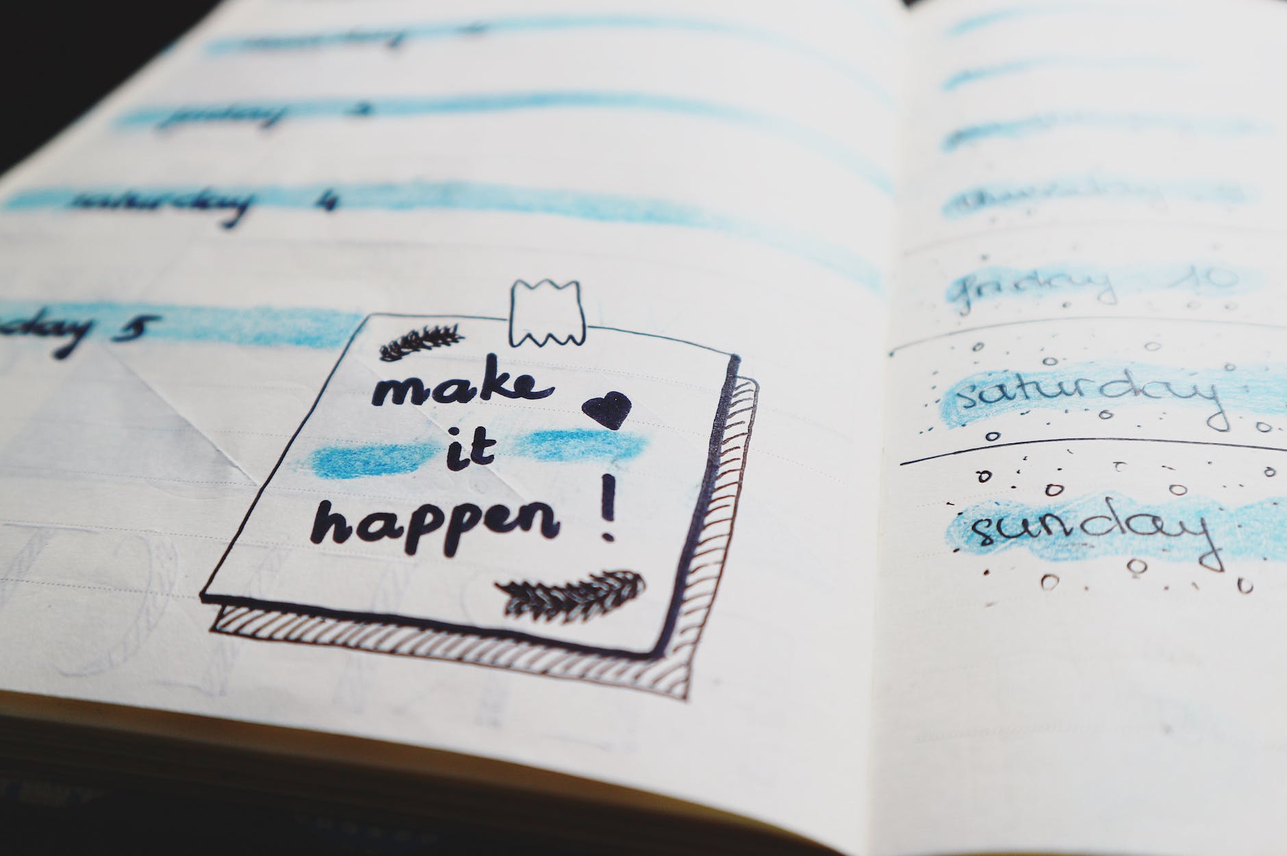 notebook with note "make it happen!"