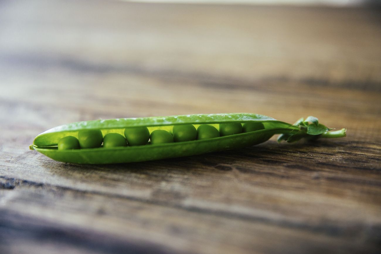 bean pod with green beans onn table