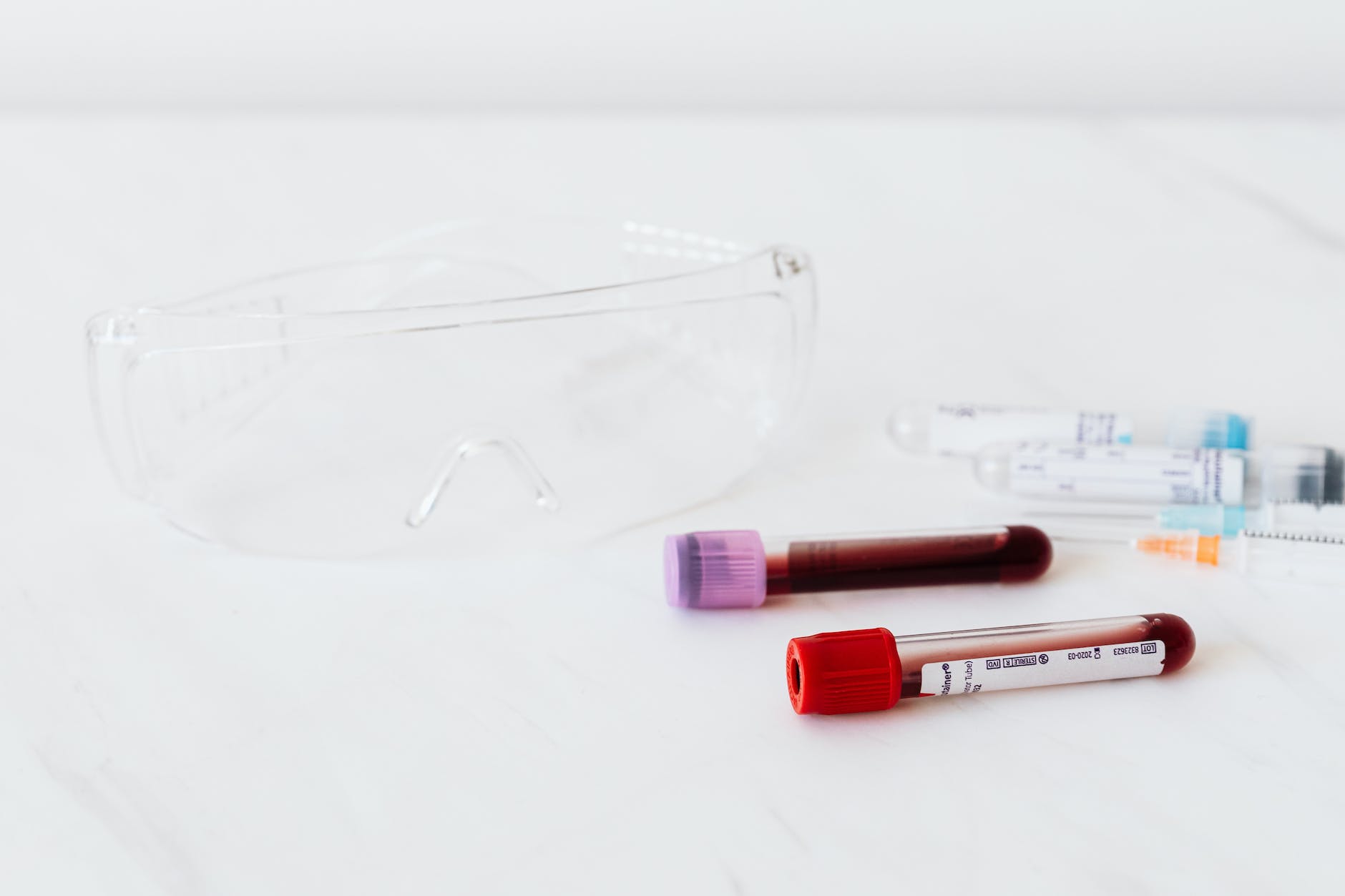 Medical equipment for blood sampling. Two vials of blood on white surface.