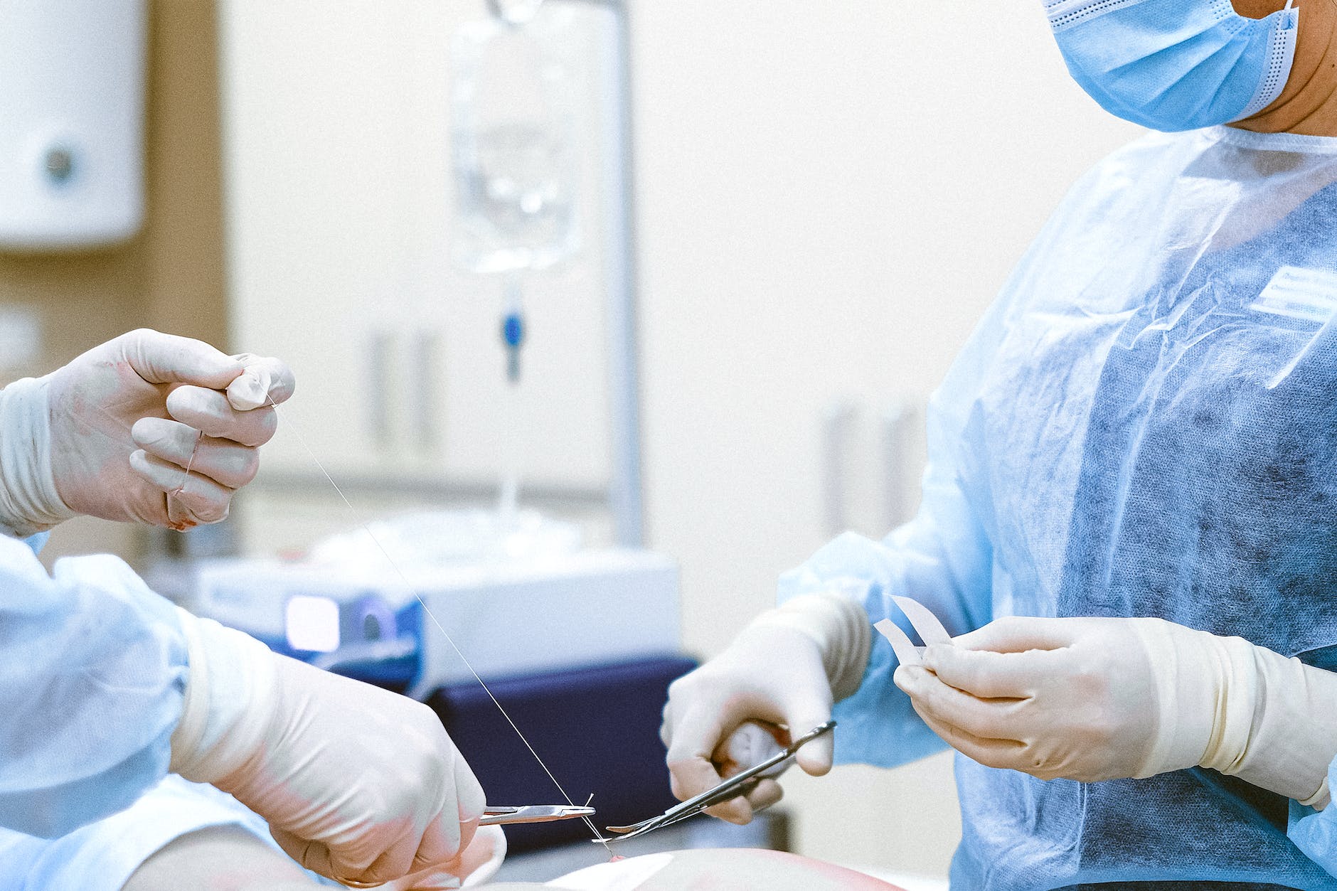 medical staff operating and stitching