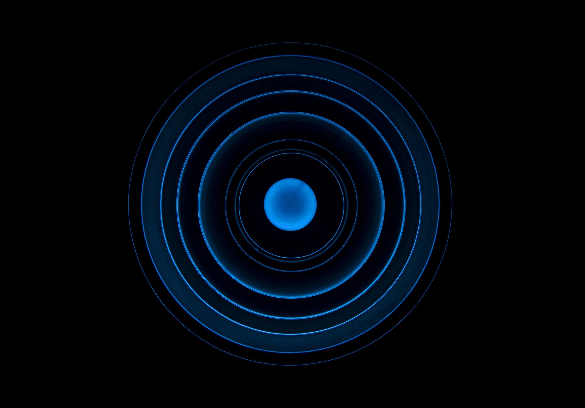 blue concentric circles on dark background