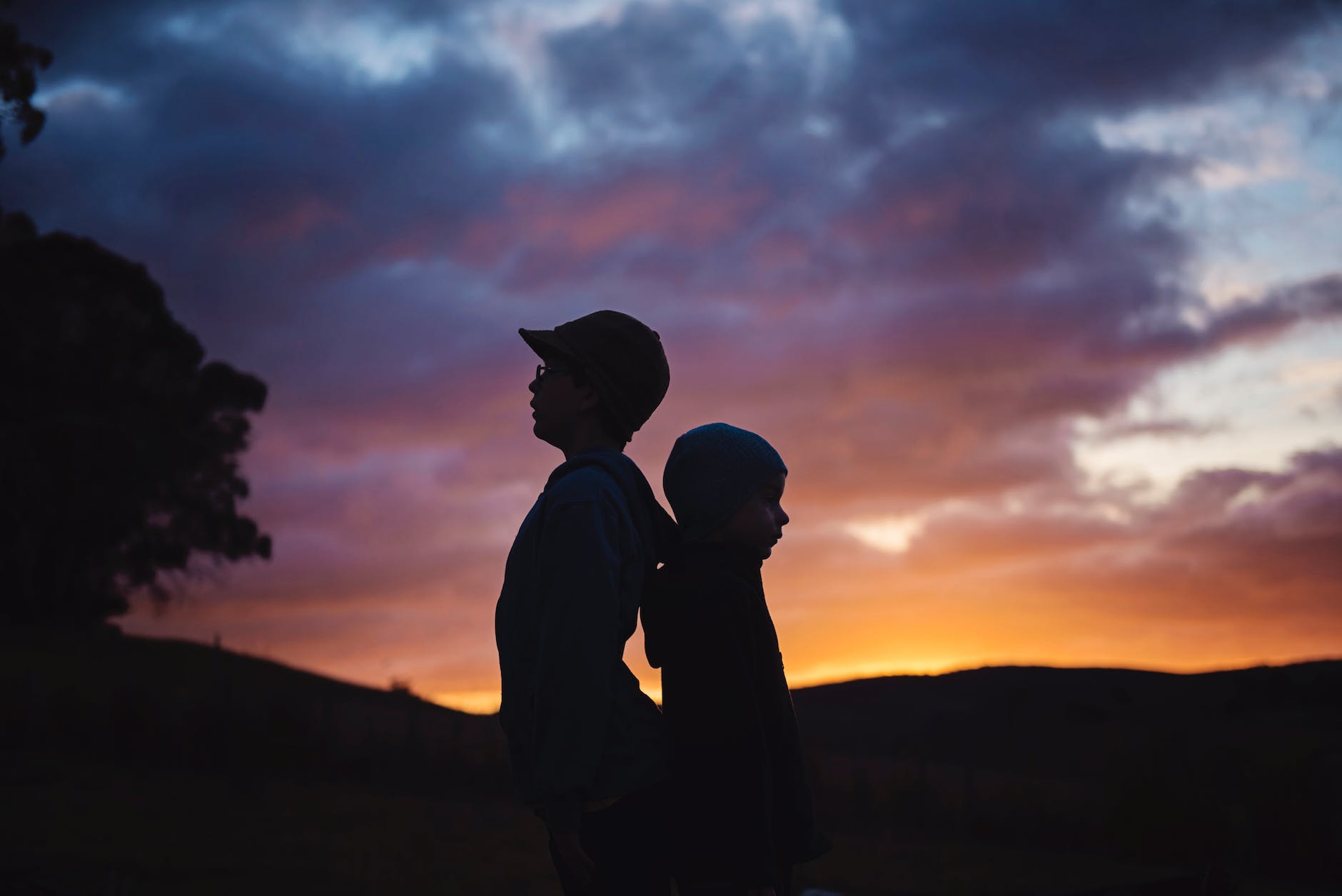 Silhouette photography of two children and sunset