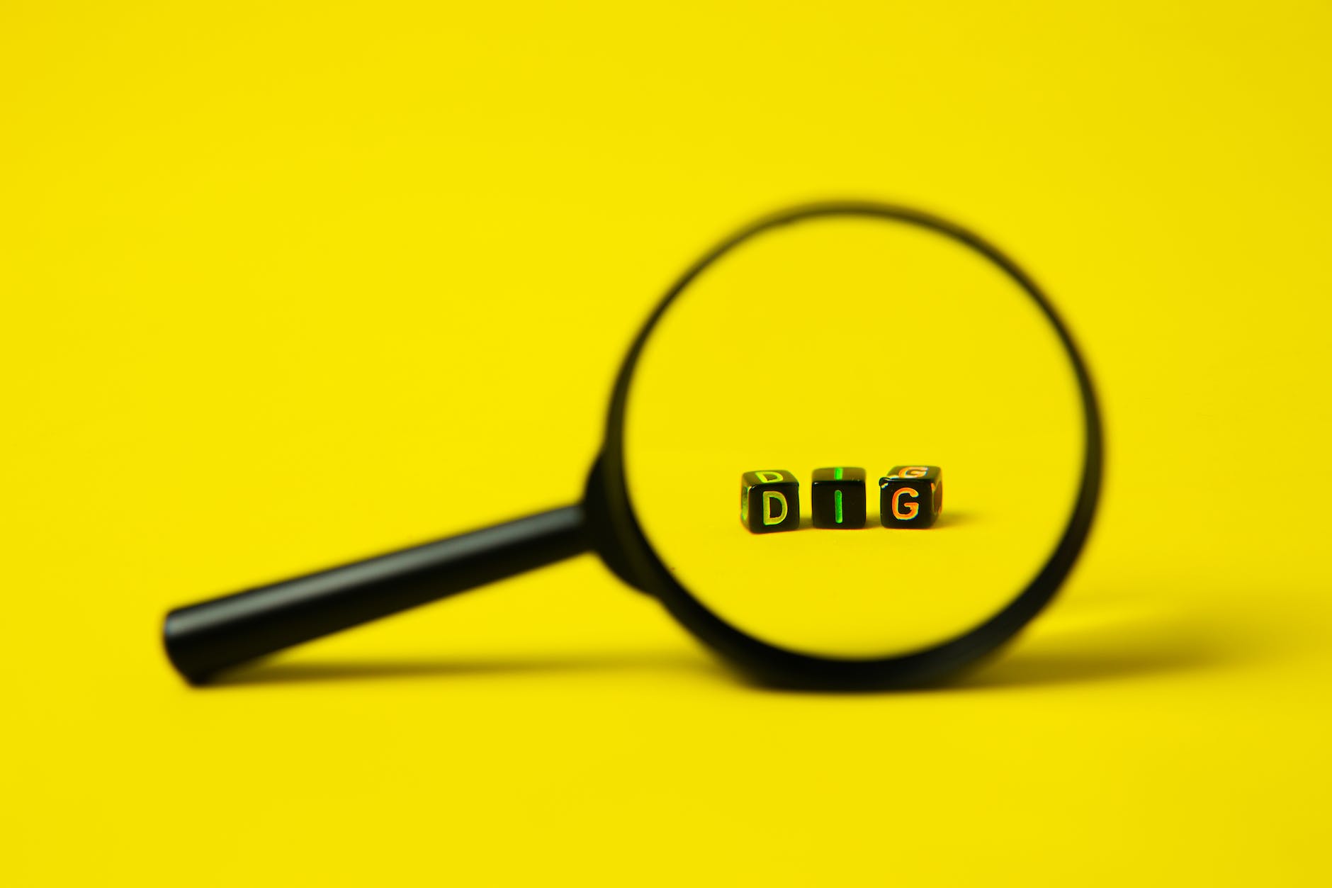 magnifying glass placed on yellow bakground